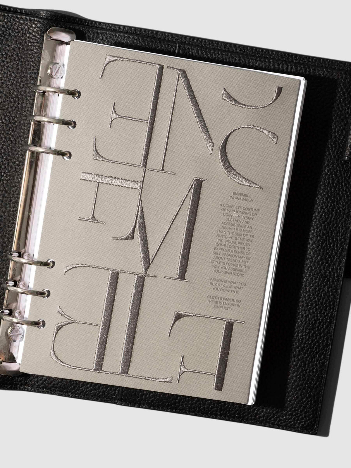 Flat lay of the A5 Ensemble Dashboard Ristretto design paired with planner inserts.