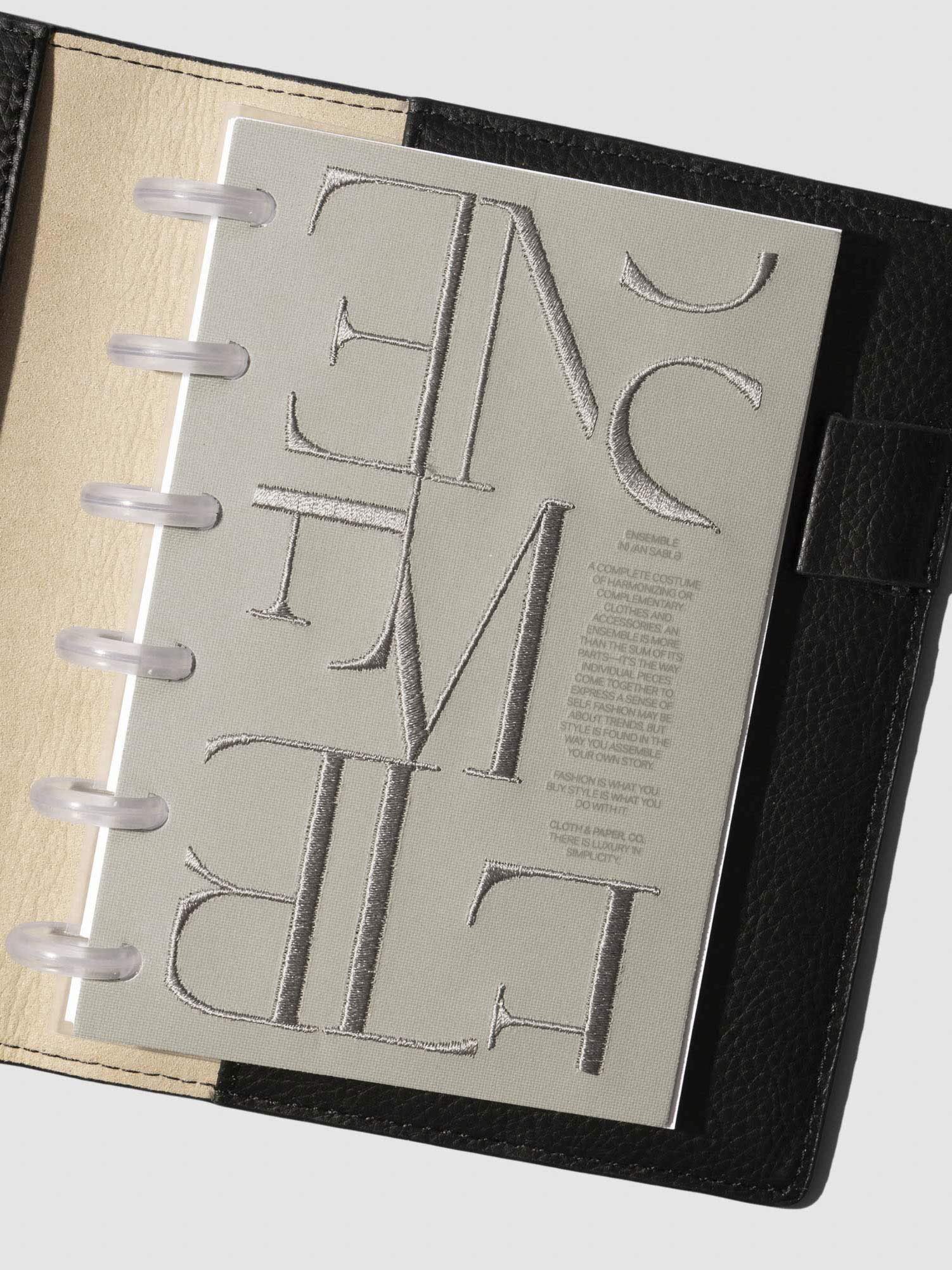 Petite Ensemble Dashboard Ristretto design shown clipped into a planner.