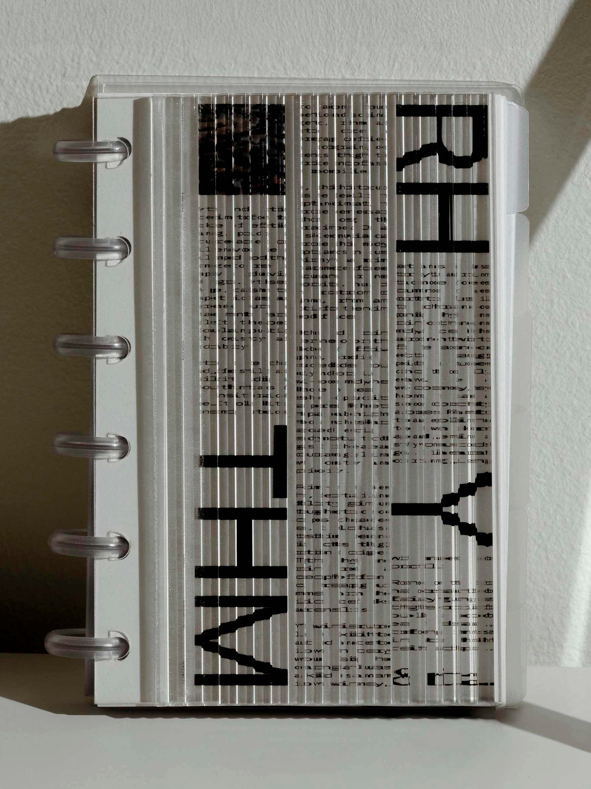 Dashboard in use as a planner cover on a neutral background. It is paired with a Rhythm and Ritual dashboard, with its visuals distorted by the fluted design of the Fluted dashboard. 