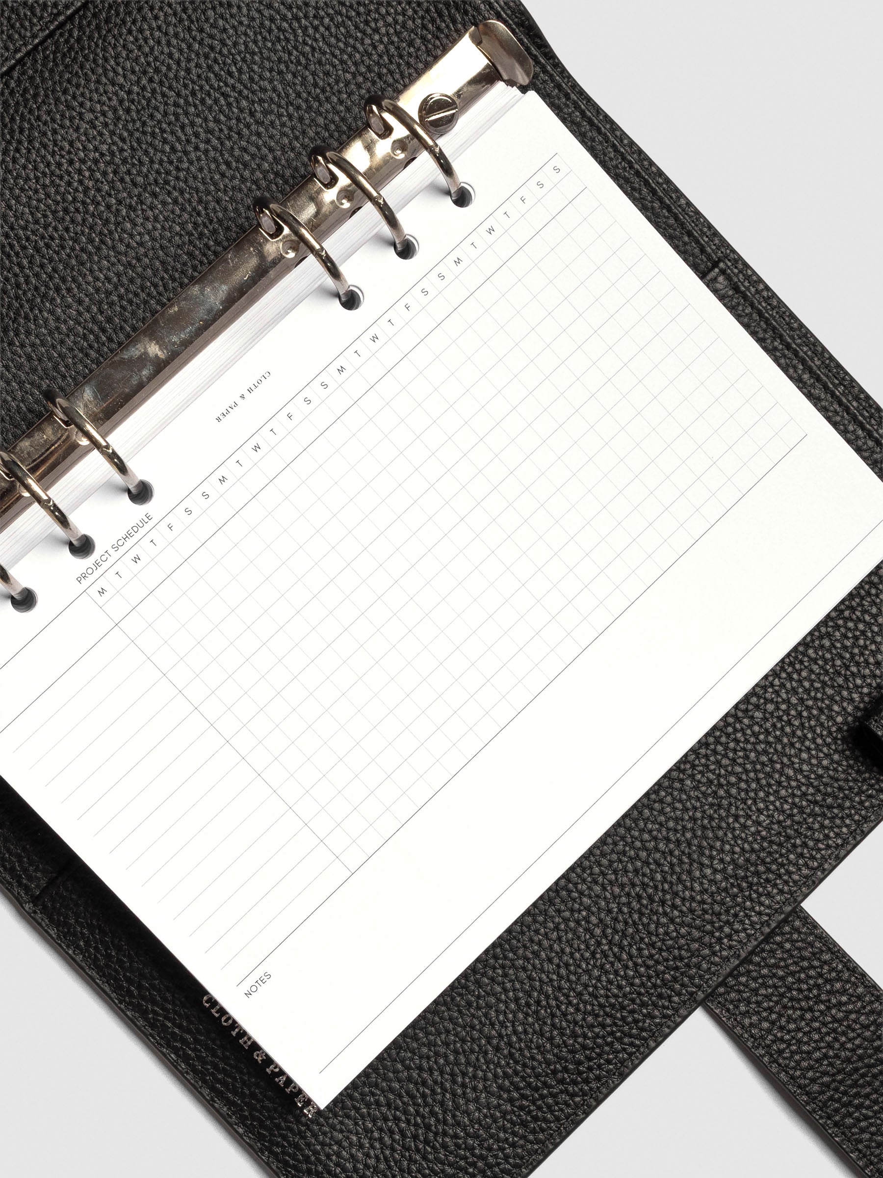 Close up of GanttChart inserts inside discbound planner and leather cover. 