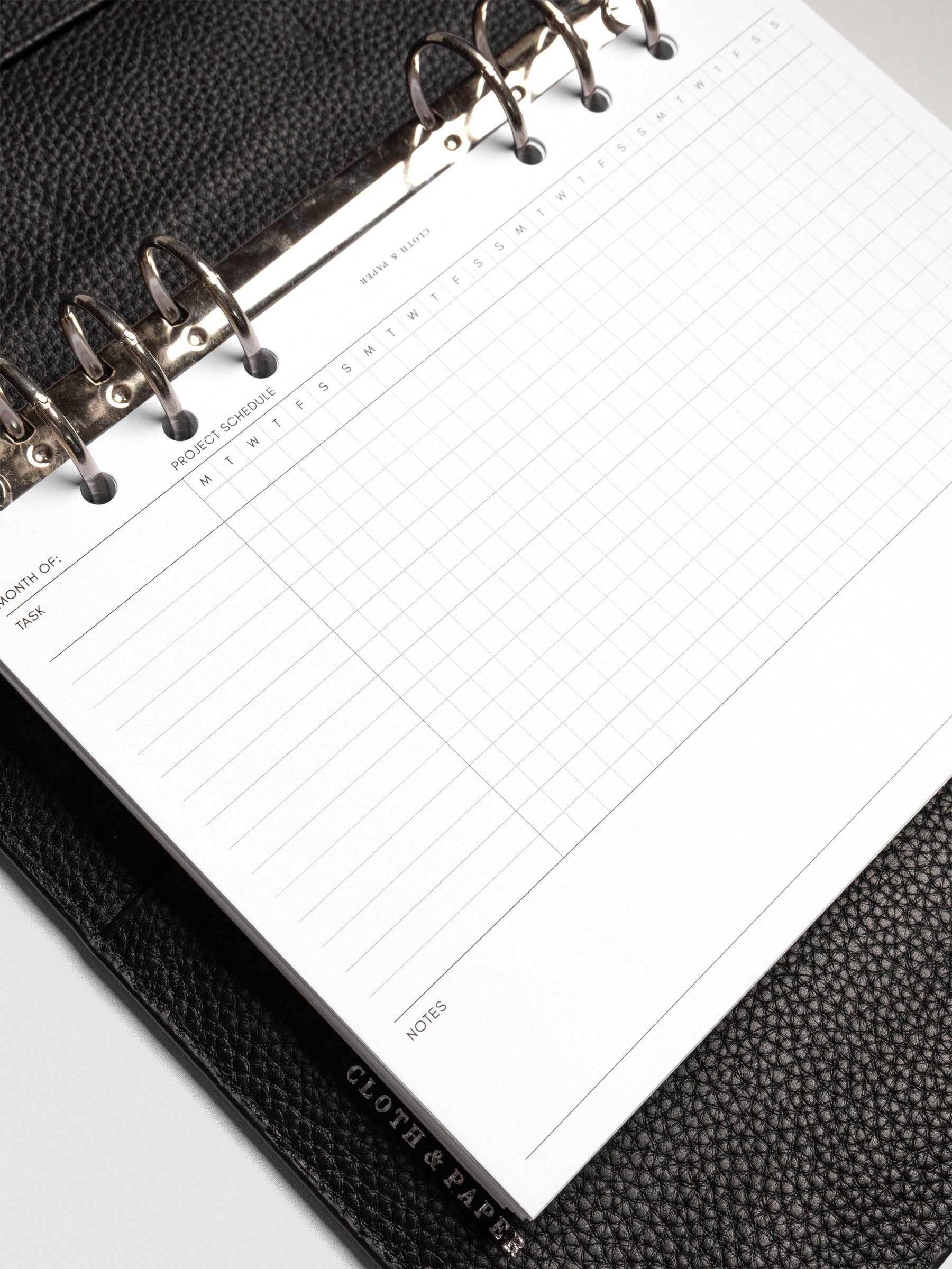 Close up of GanttChart inserts inside discbound planner and leather cover. 