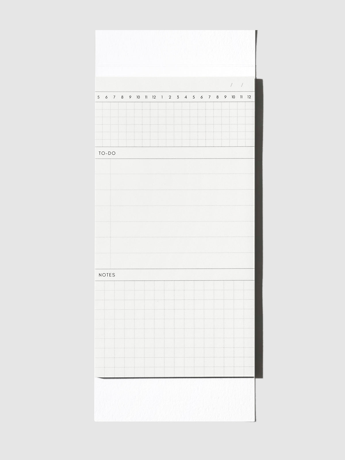 Graph Pad Sticky Note, Cloth and Paper. Sticky note on its backing displayed on a neutral background.