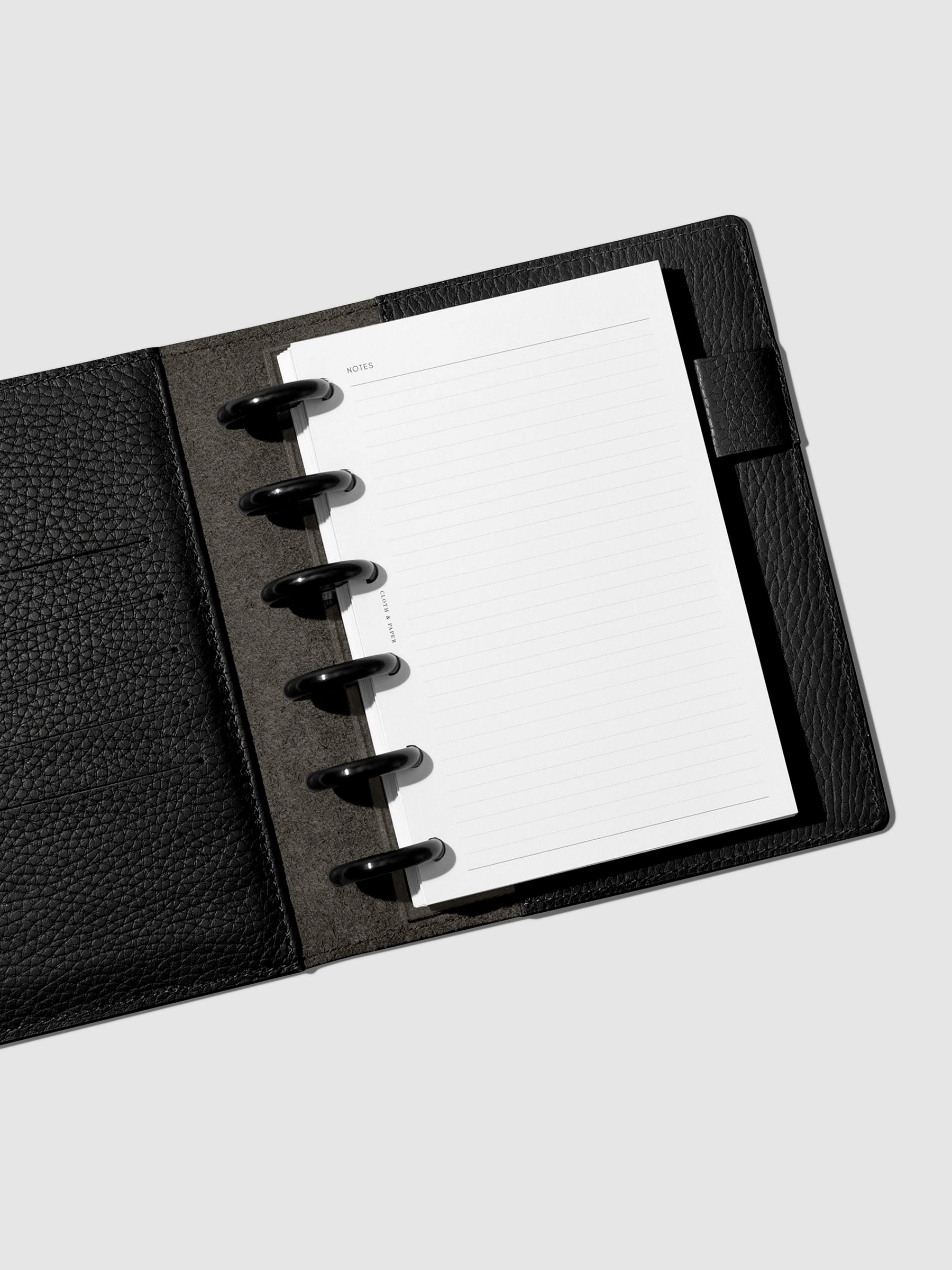 CP Petite sized planner featuring a black leather folio, black discs, and notes inserts