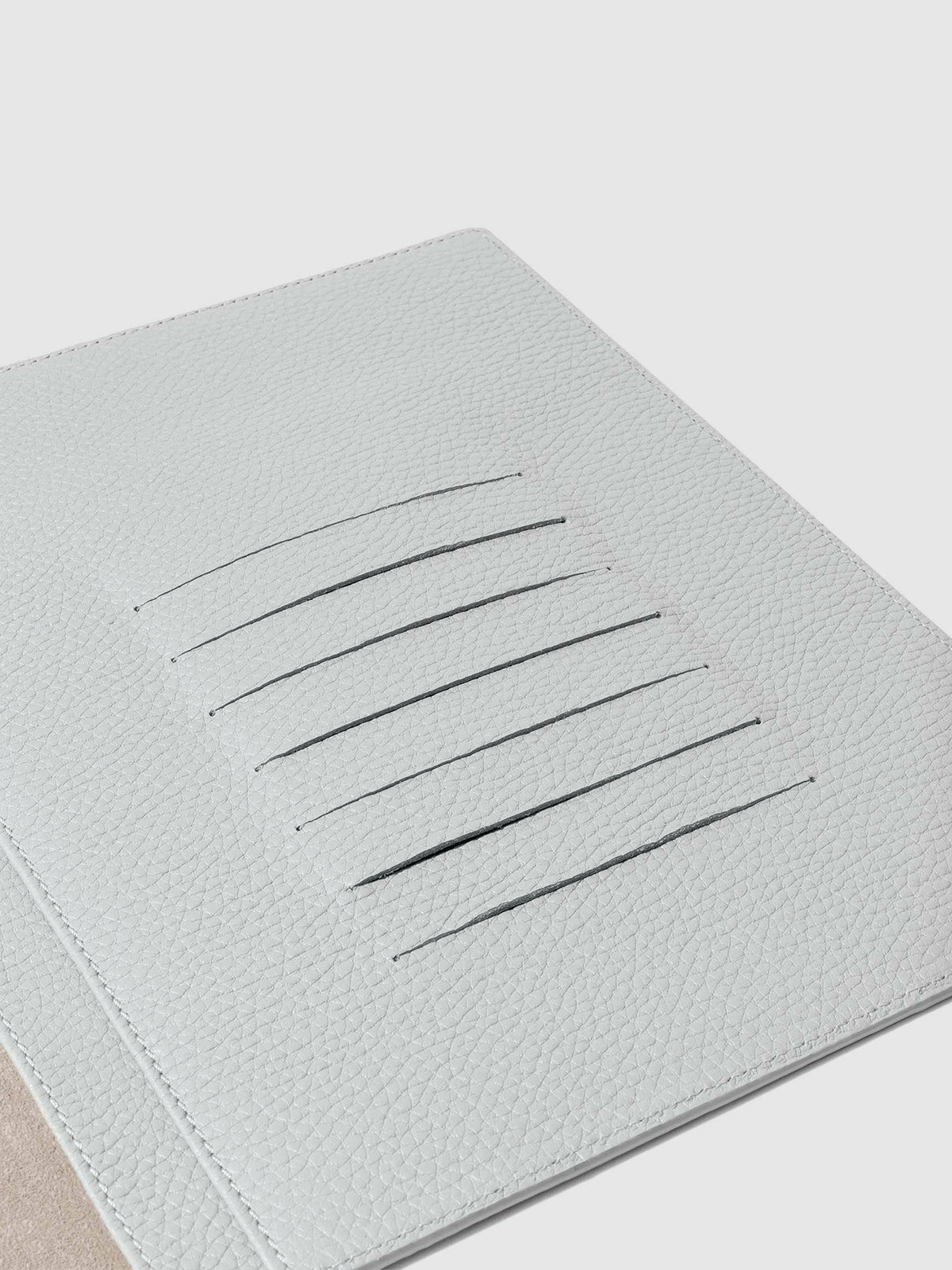 Closeup of credit card slots inside leather folio.