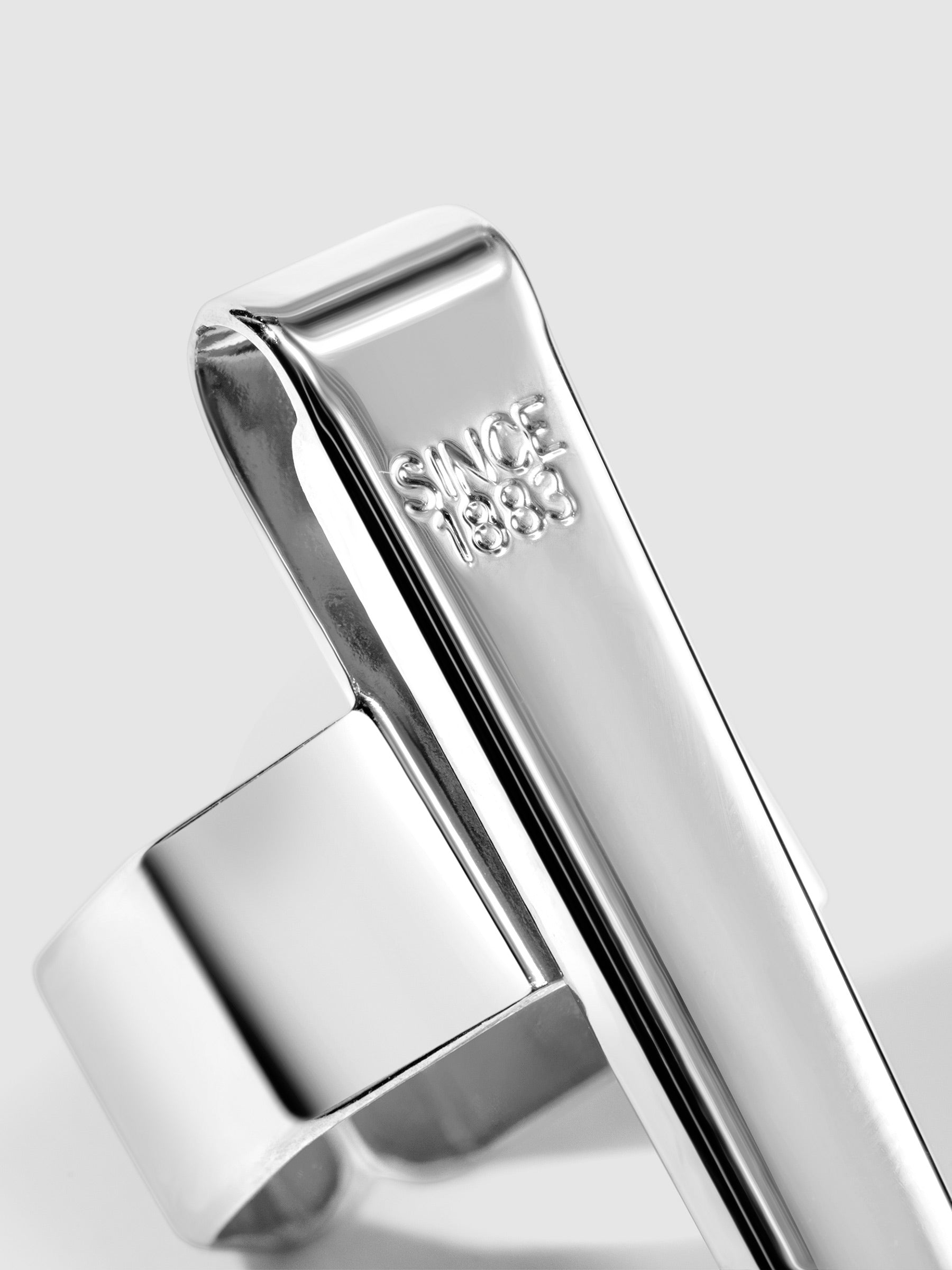 Standard silver  clip displayed on a neutral background. Closeup of text reads "Since 1883"