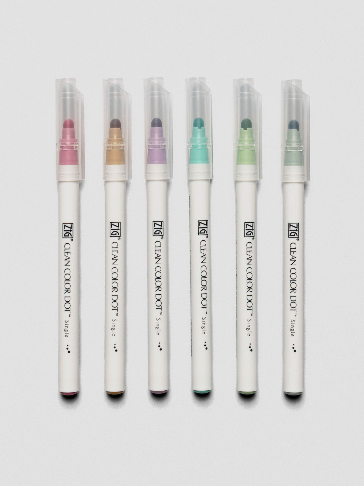 Set of six Kuretake ZIG Clean Color Dot Markers displayed vertically with caps on, showcasing pastel marker colors.