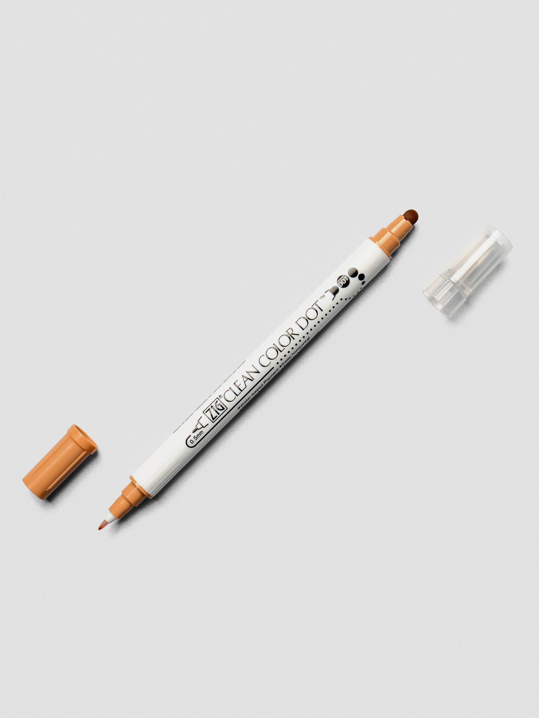 Fawn-colored Kuretake ZIG Clean Color Dot Dual Tip Marker with caps off, revealing the detailed fine tip and the rounded dot tip.