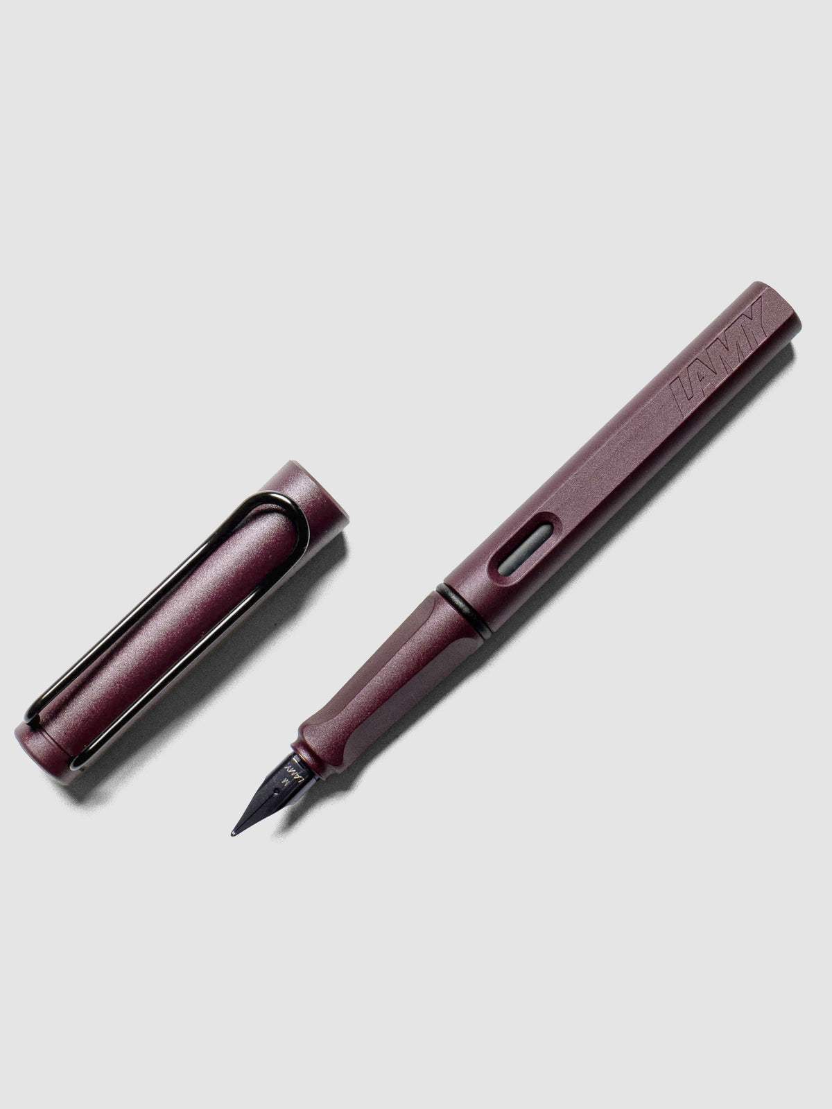 LAMY Safari Fountain Pen in the color Scarlett with Medium nib shown diagonally with the cap off. 