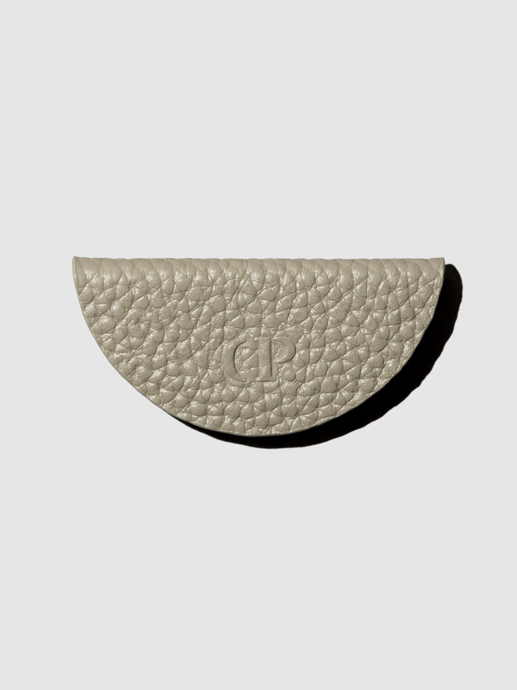 Beige leather bookmark on a neutral background.