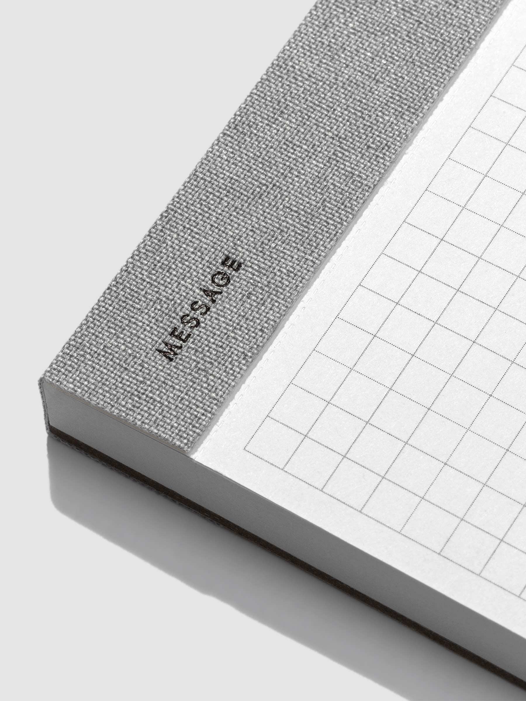 Closeup of the text on the bottom left corner of the notepad that reads "message."