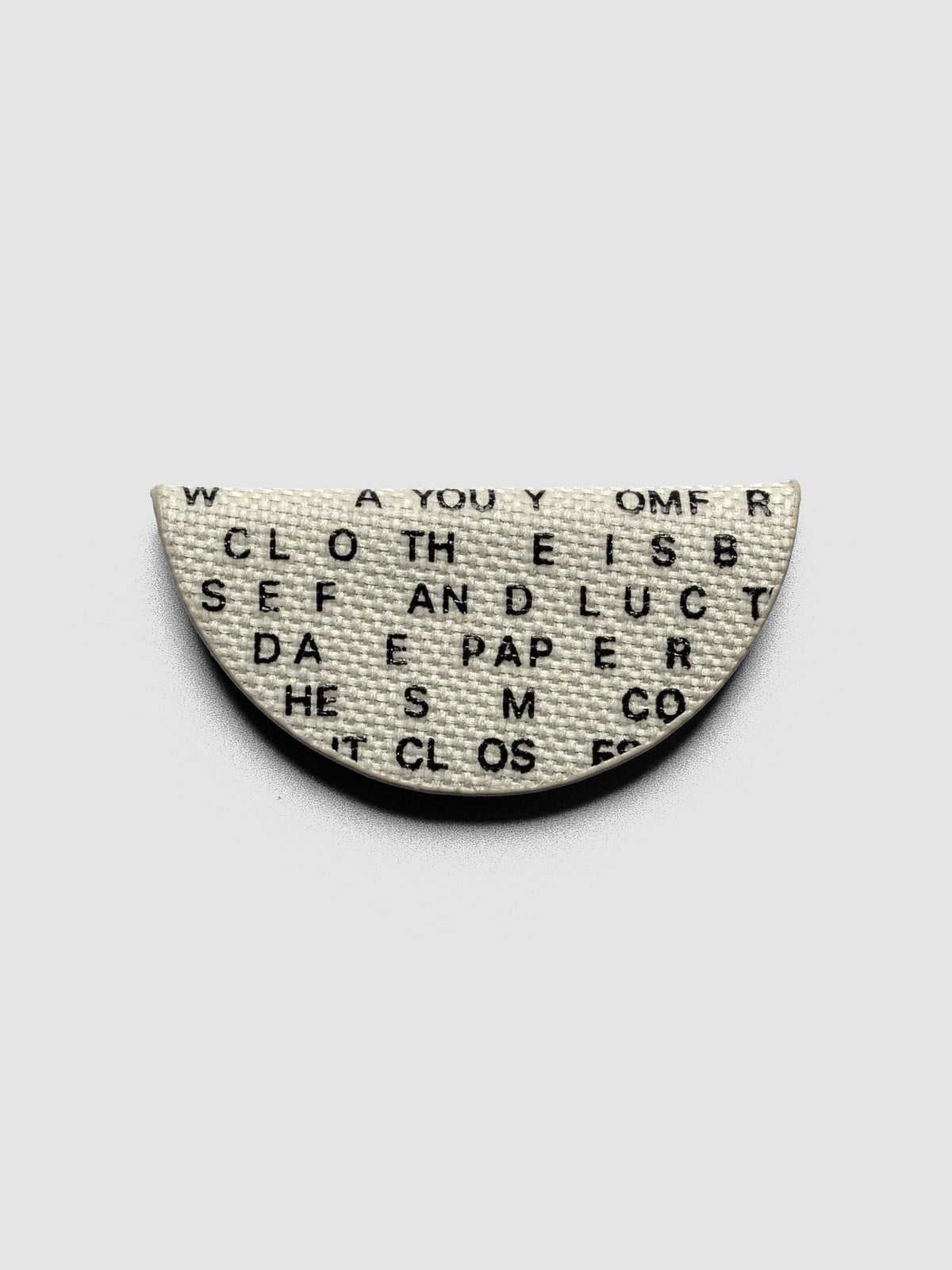 Magnetic Bookmark | Bookcloth | Letters folded in half on a neutral background.
