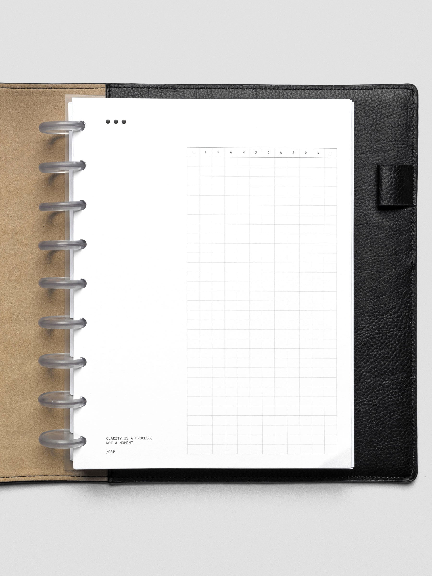 Mindful Moments Planner Dashboard in size HP Classic shown discbound in a black leather folio.