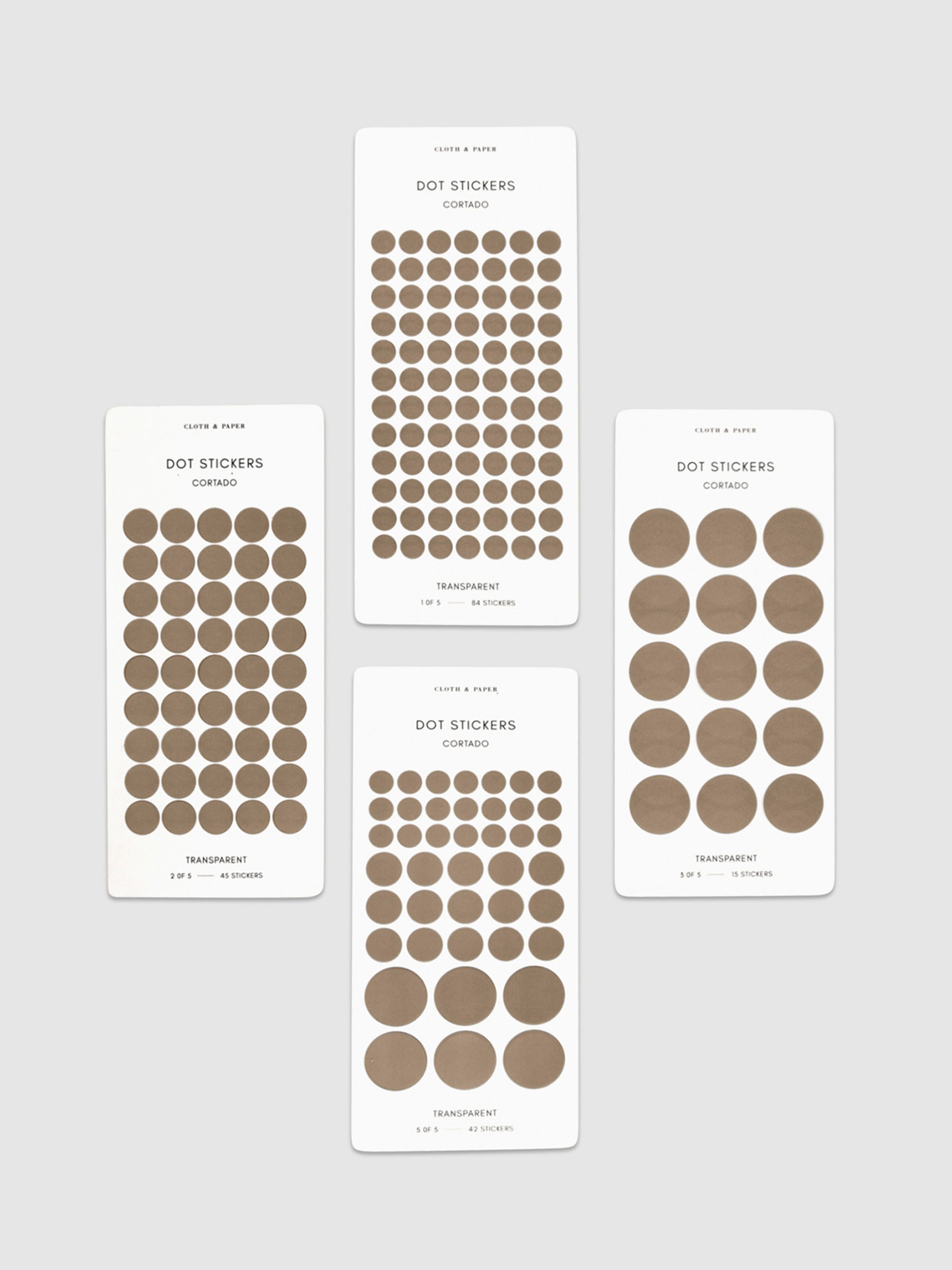 Four sheets of Cortado dot stickers in different sizes shown parallel to each other on a neutral background.