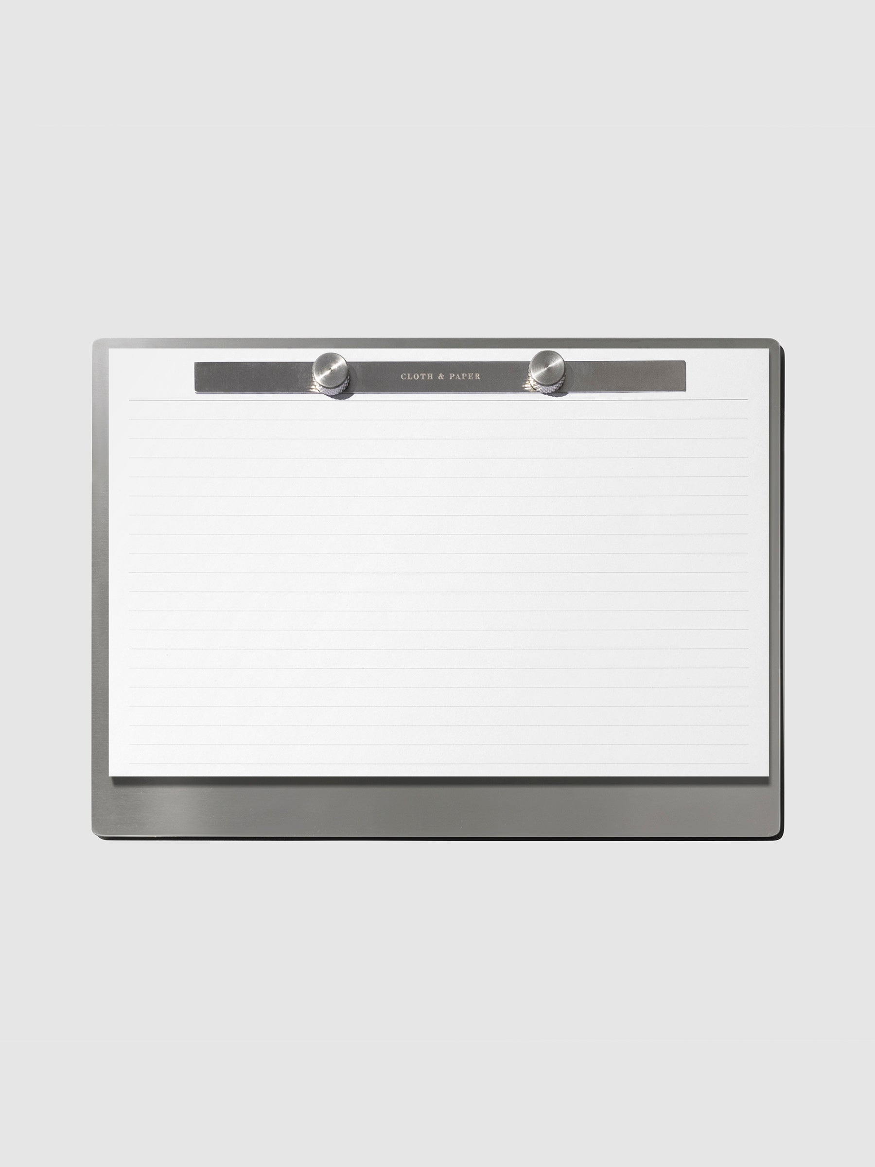 Modern Bound Notepad Insert Refills, lined, filled on the Modern Bound Notepad board, resting on a light gray background