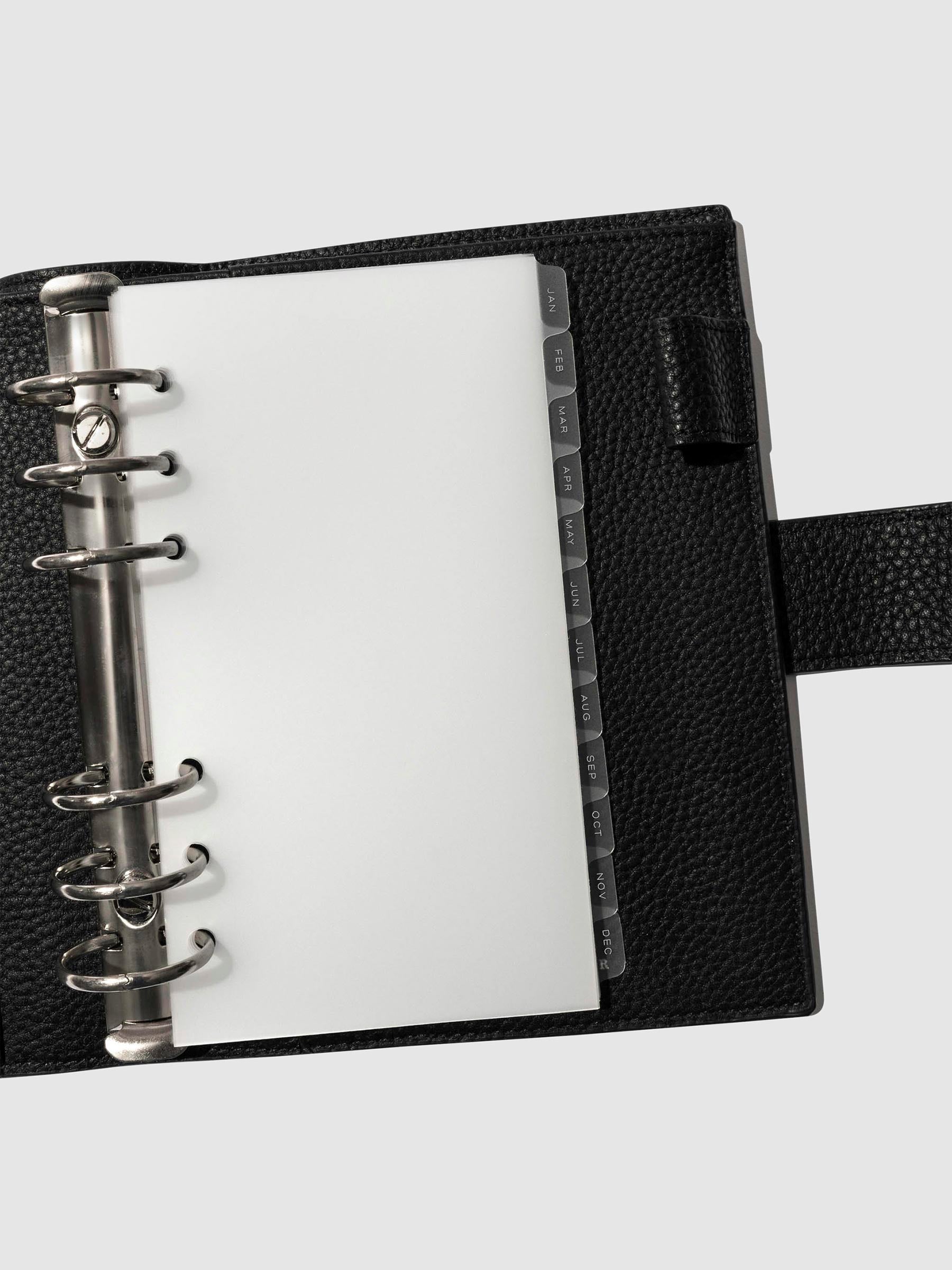 Personal Sized Planner in a black leather agenda featuring monthly side tab planner dividers.