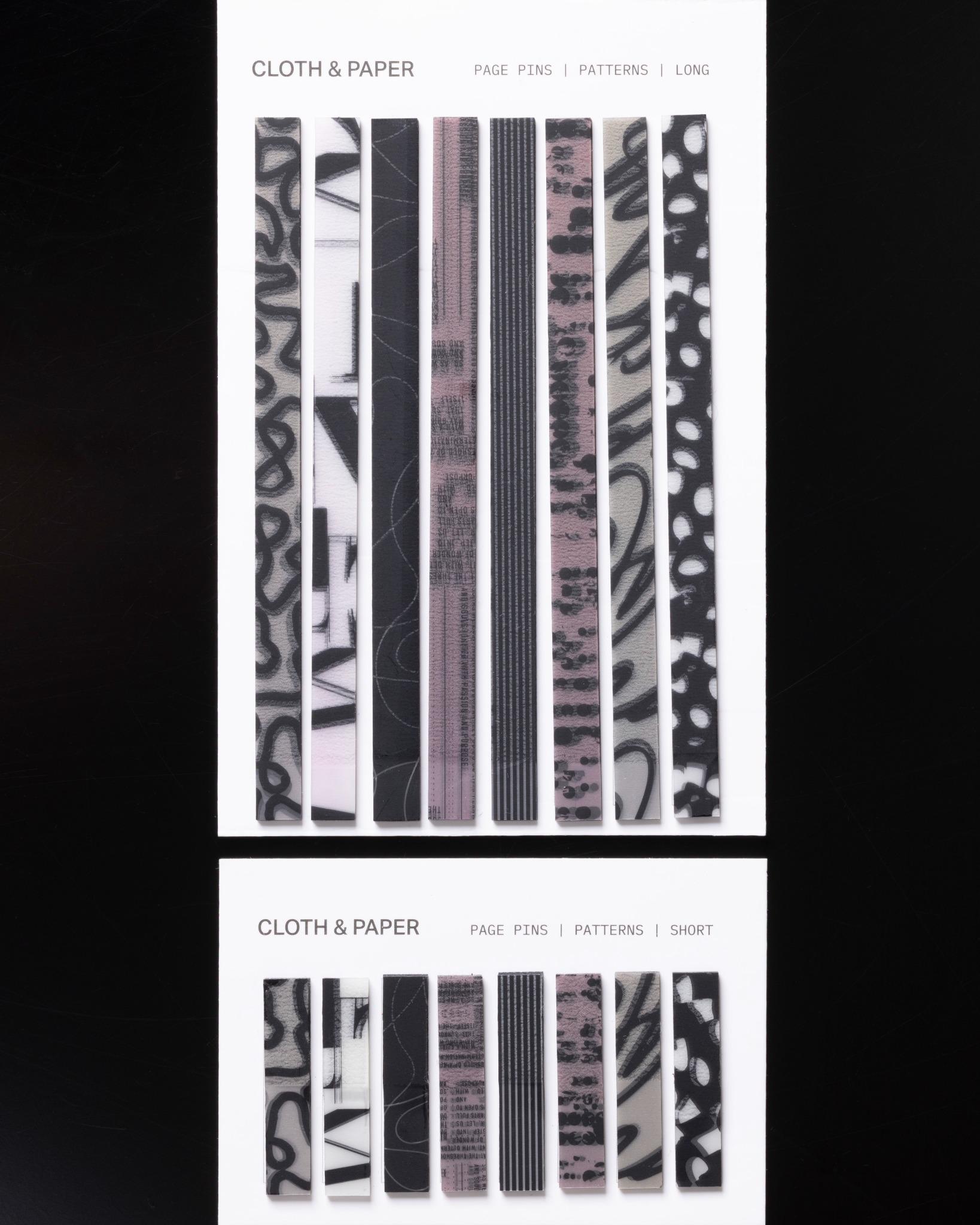 Flat lay of Cloth & Paper Page Pins in both Long and Short sizes, featuring modern graphic patterns in black, blush, and white