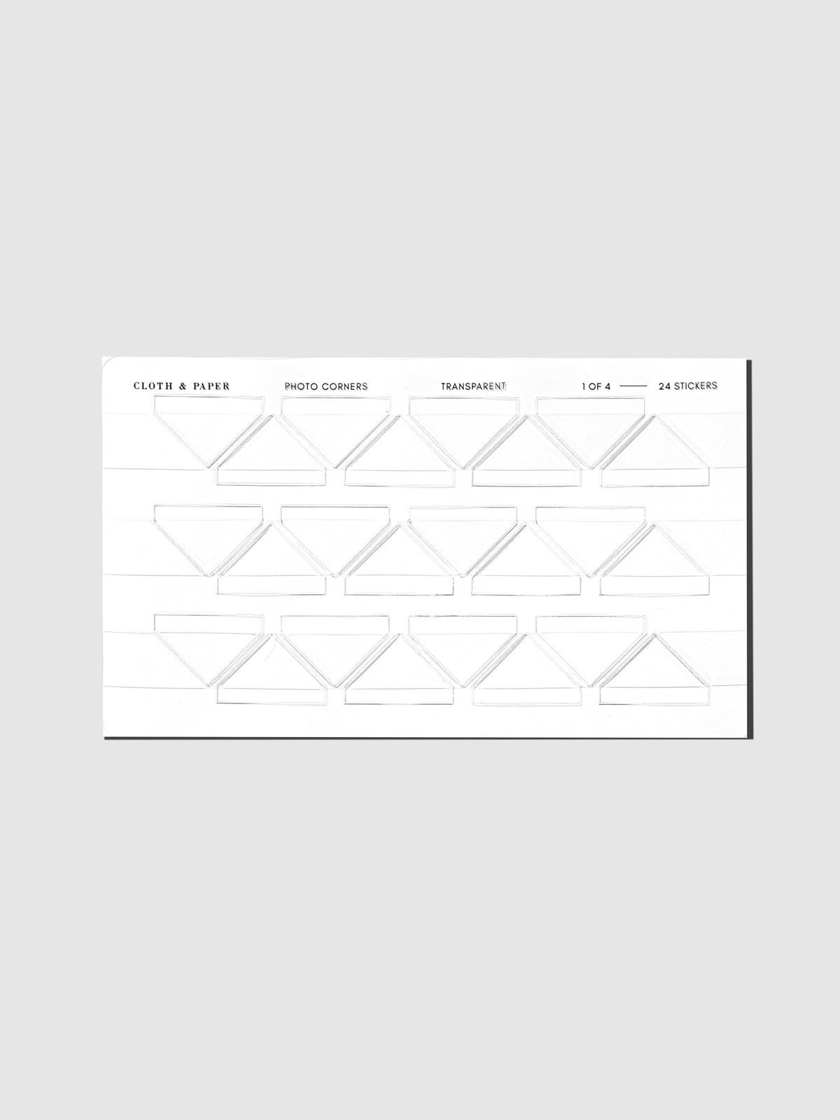 Set of clear photo corner stickers displayed on a neutral background.