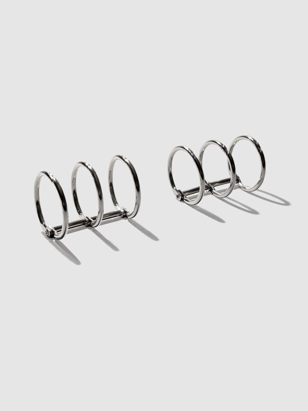 Silver rings displayed on a neutral background.
