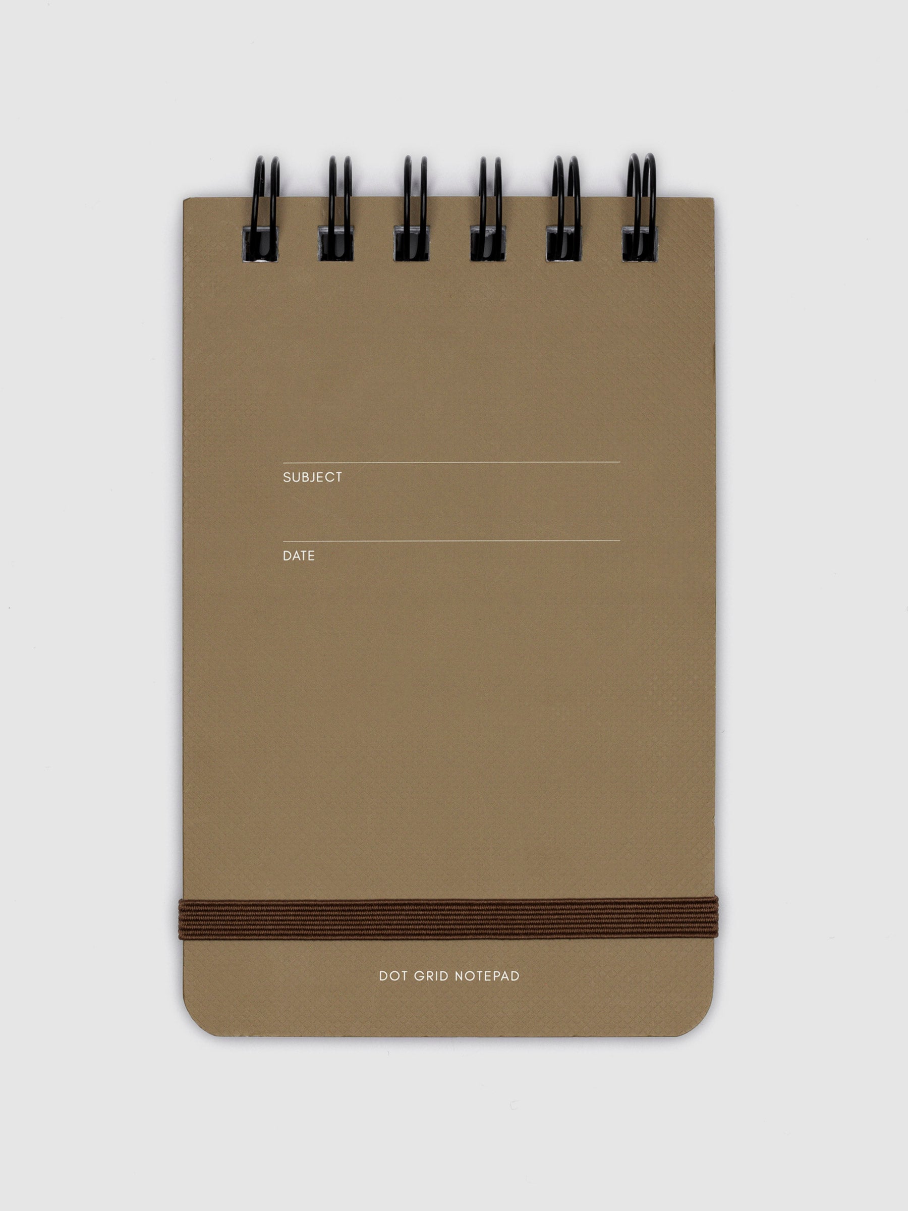Dot grid notepad displayed on a neutral background. 