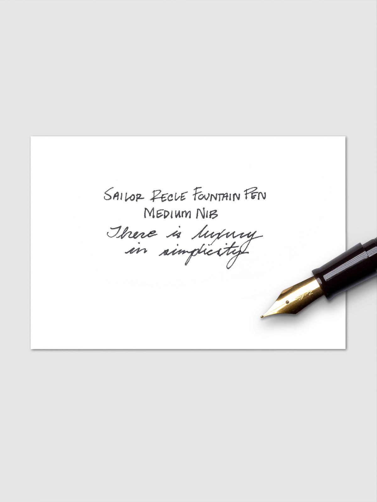 Handwritten example of black ink cartridge pictured with the nib of a fountain pen.