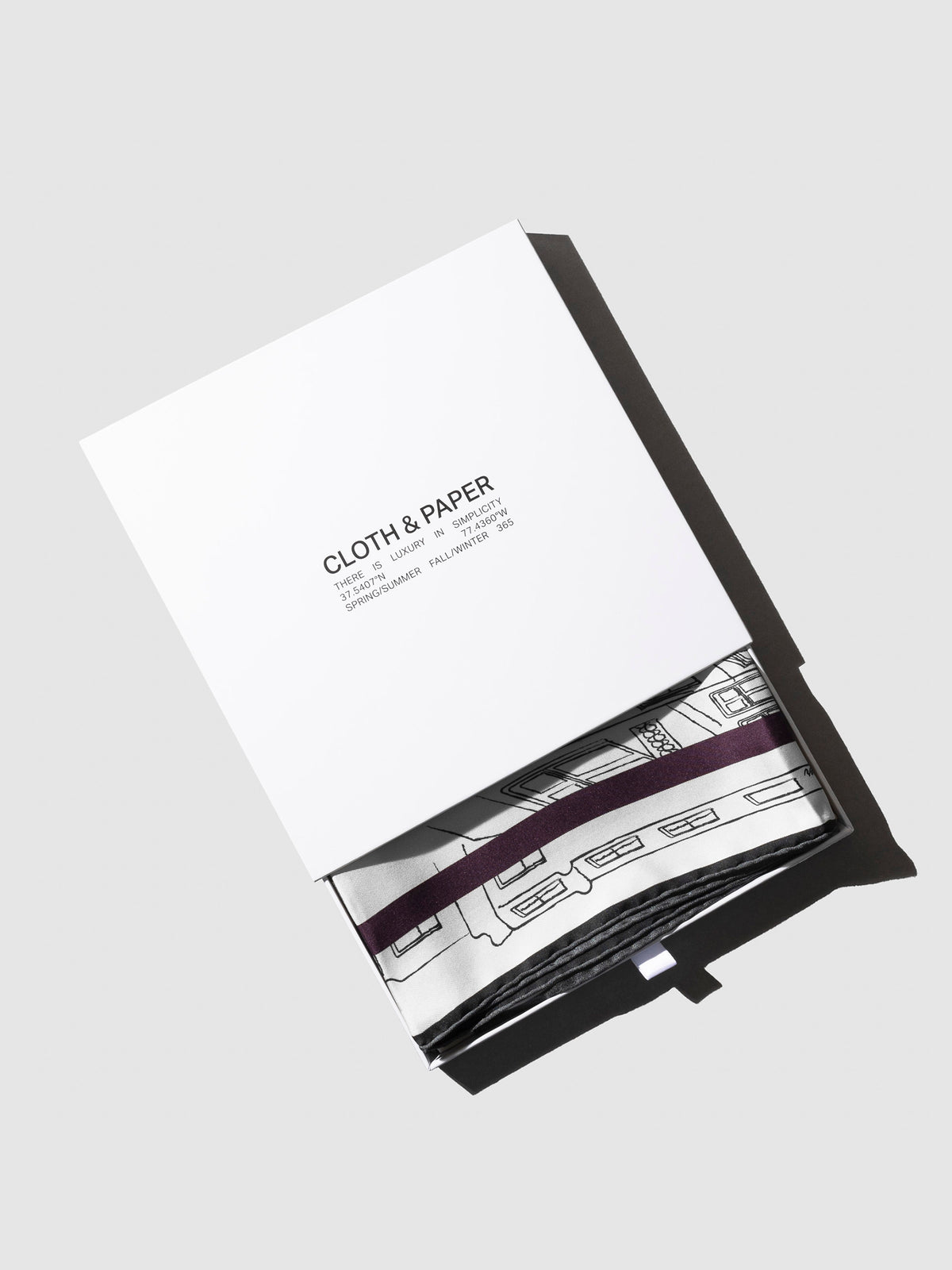 Scarf shown in its storage box, slightly exposed.