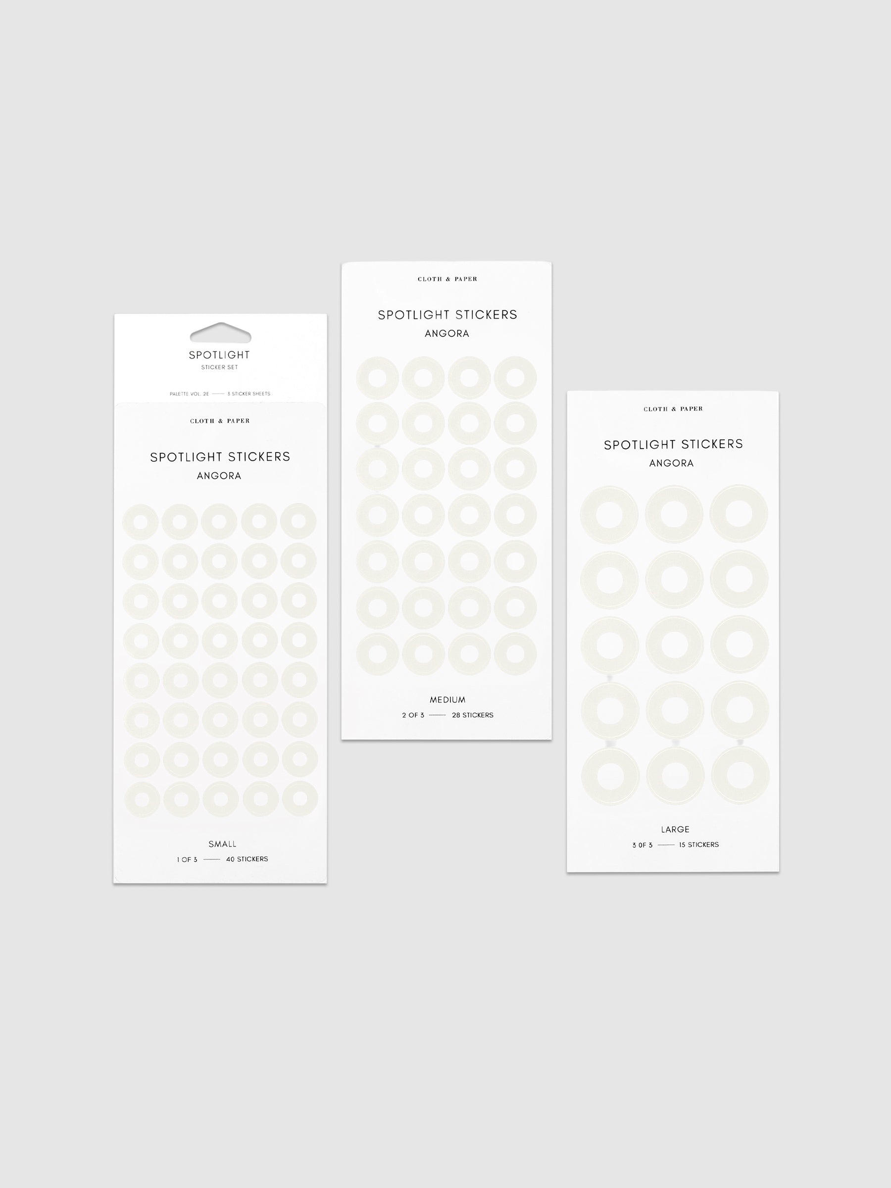 Three sheets of spotlight stickers in small, medium, and large sizing arranged together on a neutral background.