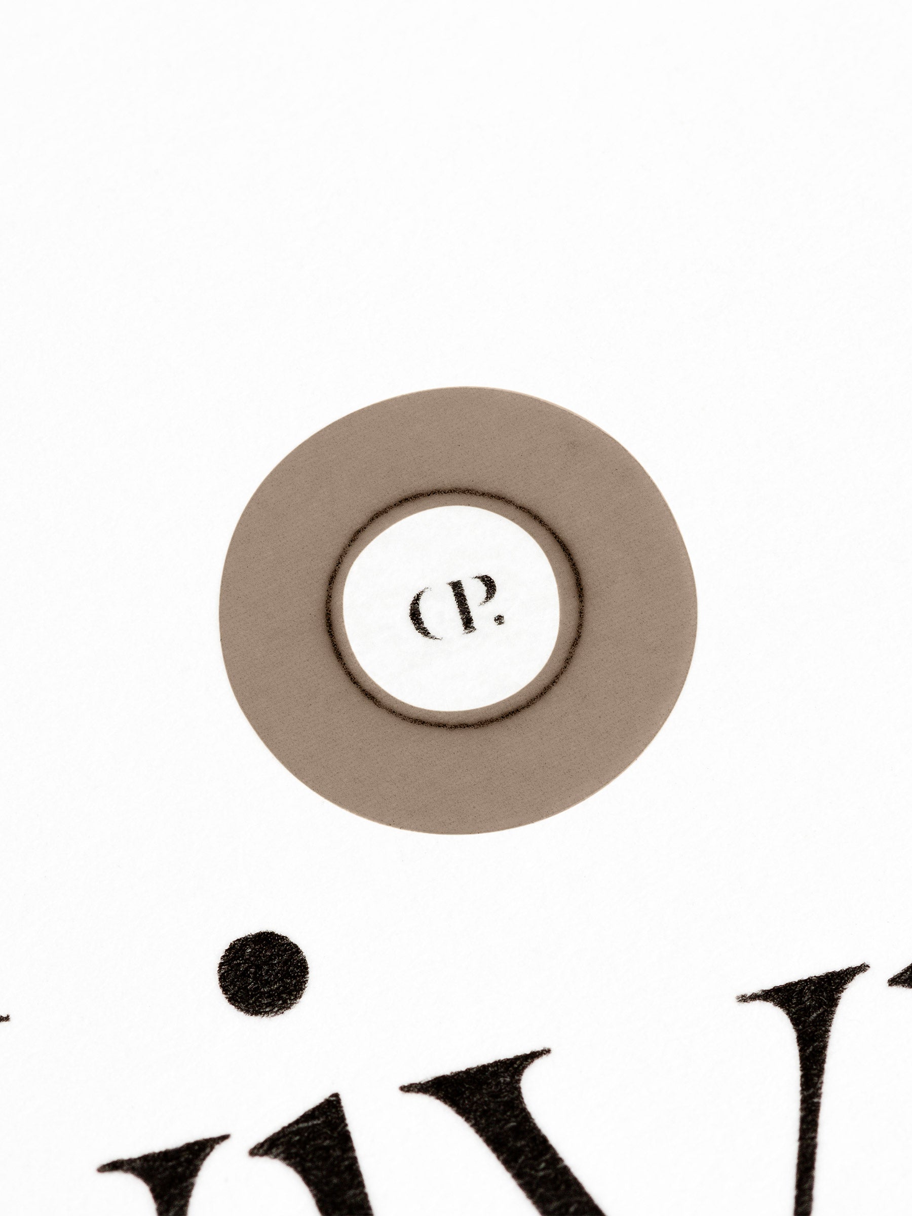 Small sticker in use, placed over the Cloth and Paper logo on a sheet of paper.