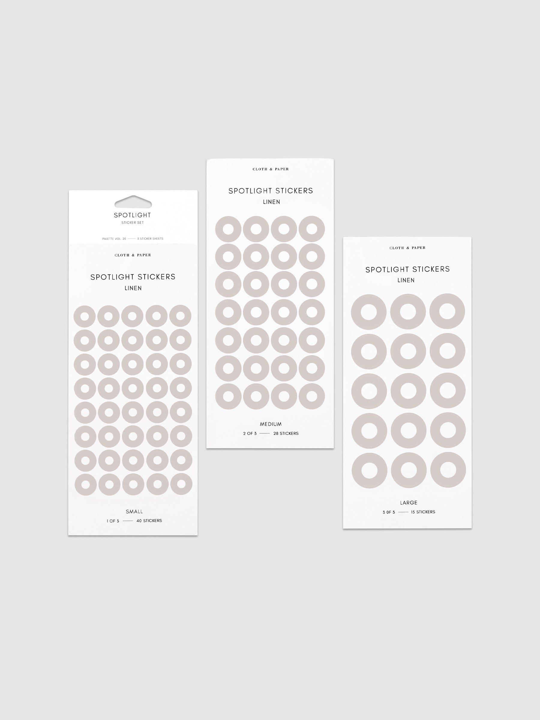 Three sheets of spotlight stickers in small, medium, and large sizing arranged together on a neutral background.