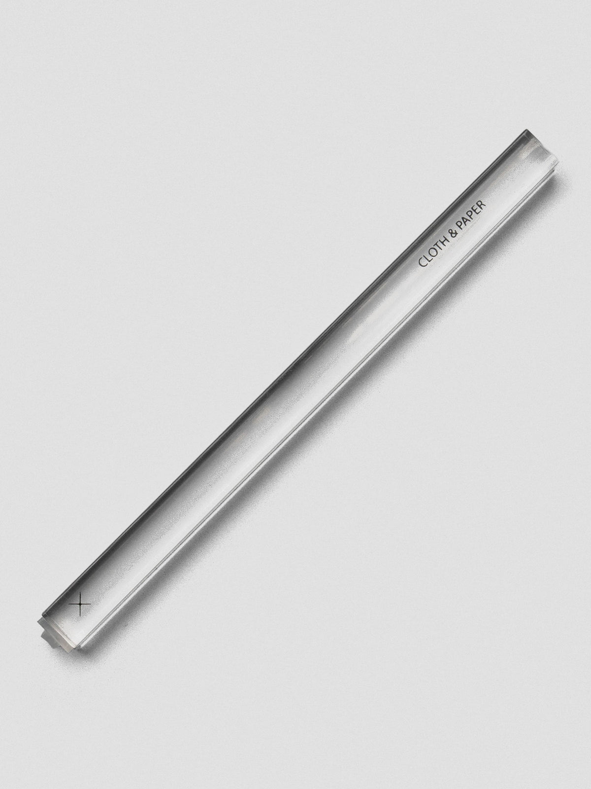 Single clear acrylic stamp stick with an “X” icon on the end and the Cloth & Paper logo on the side.