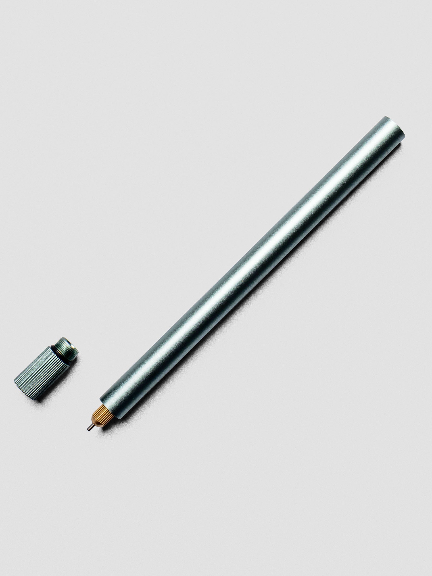 Uncapped sage Lumos Pro Pen with tip exposed.