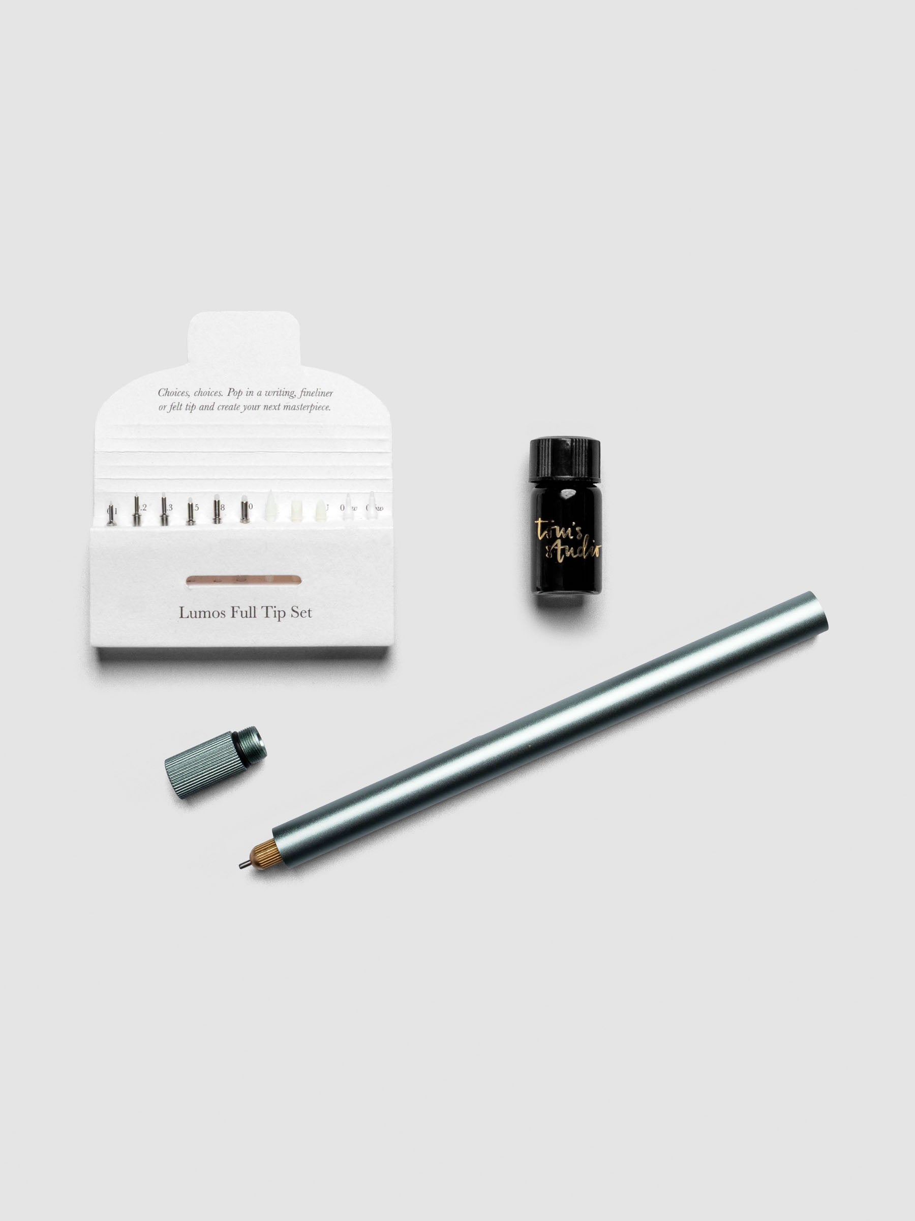 Sage green Lumos Pro Single Tip Pen diagonally, uncapped, with nib set and ink resevoir.