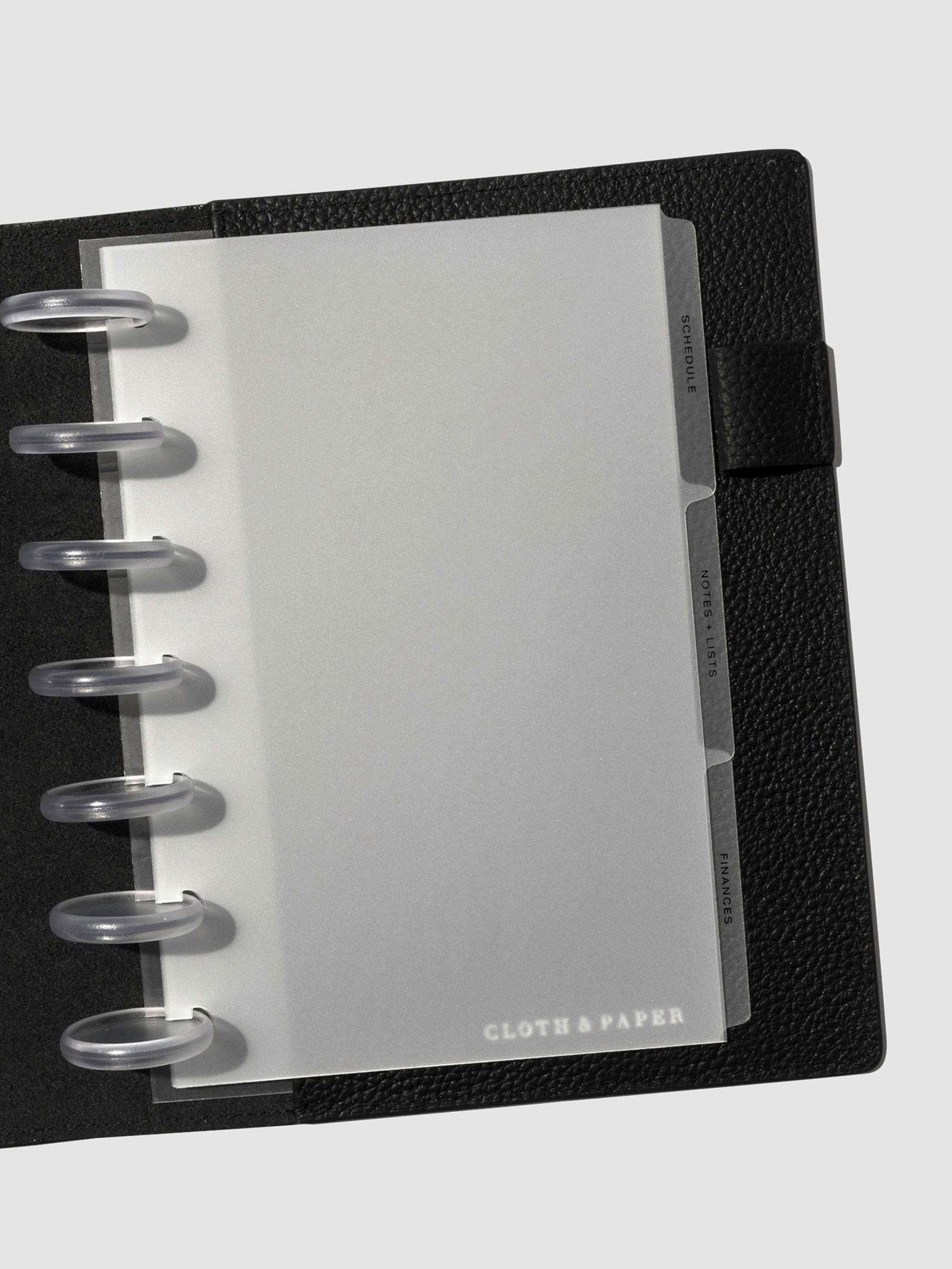 Black foil tabs displayed in use inside a  leather folio.