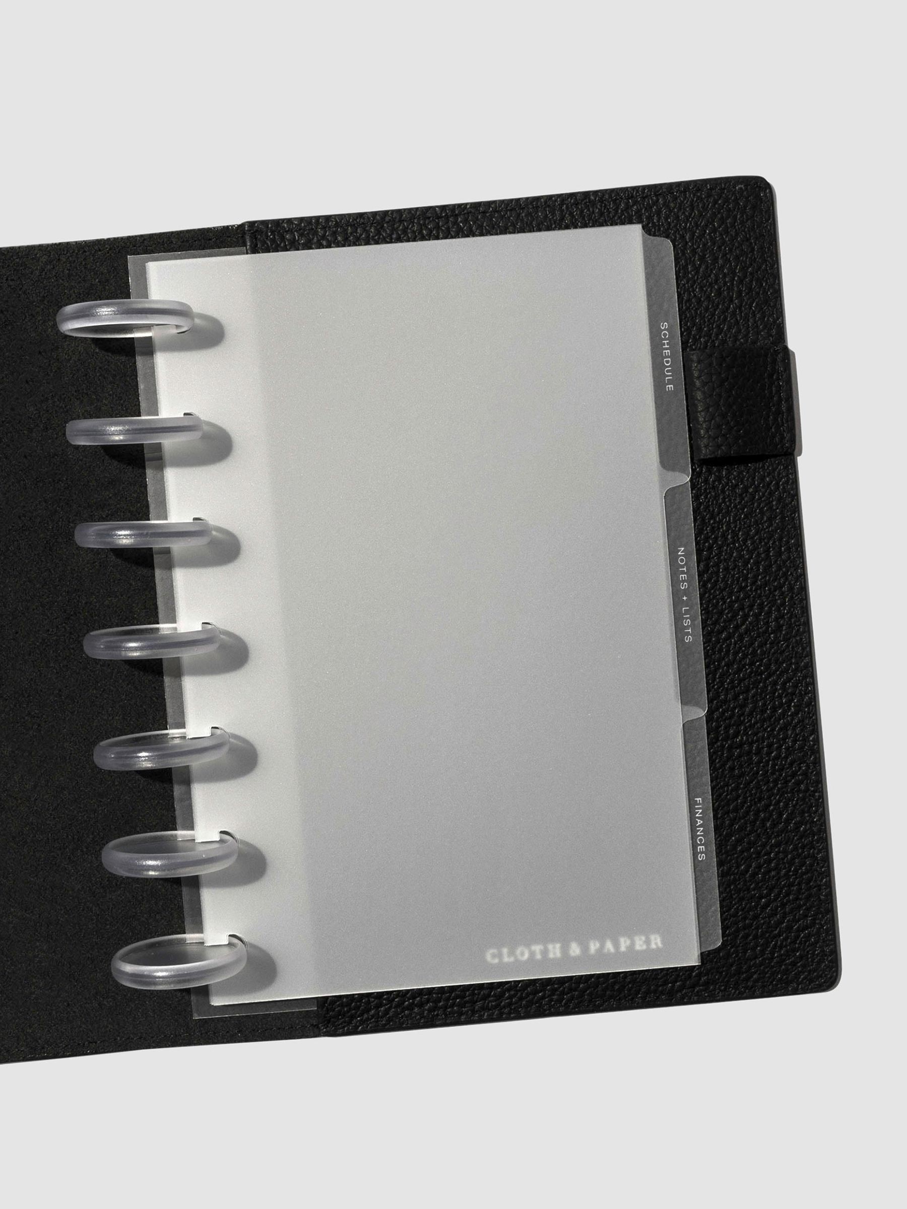 White foil tabs displayed in use inside a  leather folio.