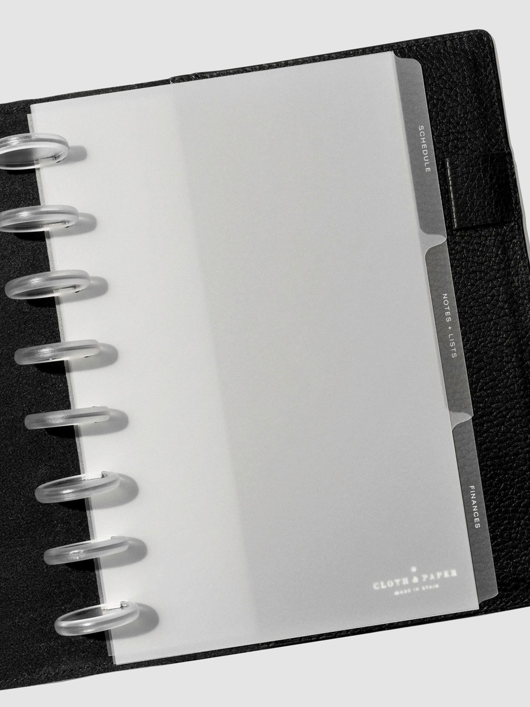 White foil tabs displayed in use inside a  leather folio.