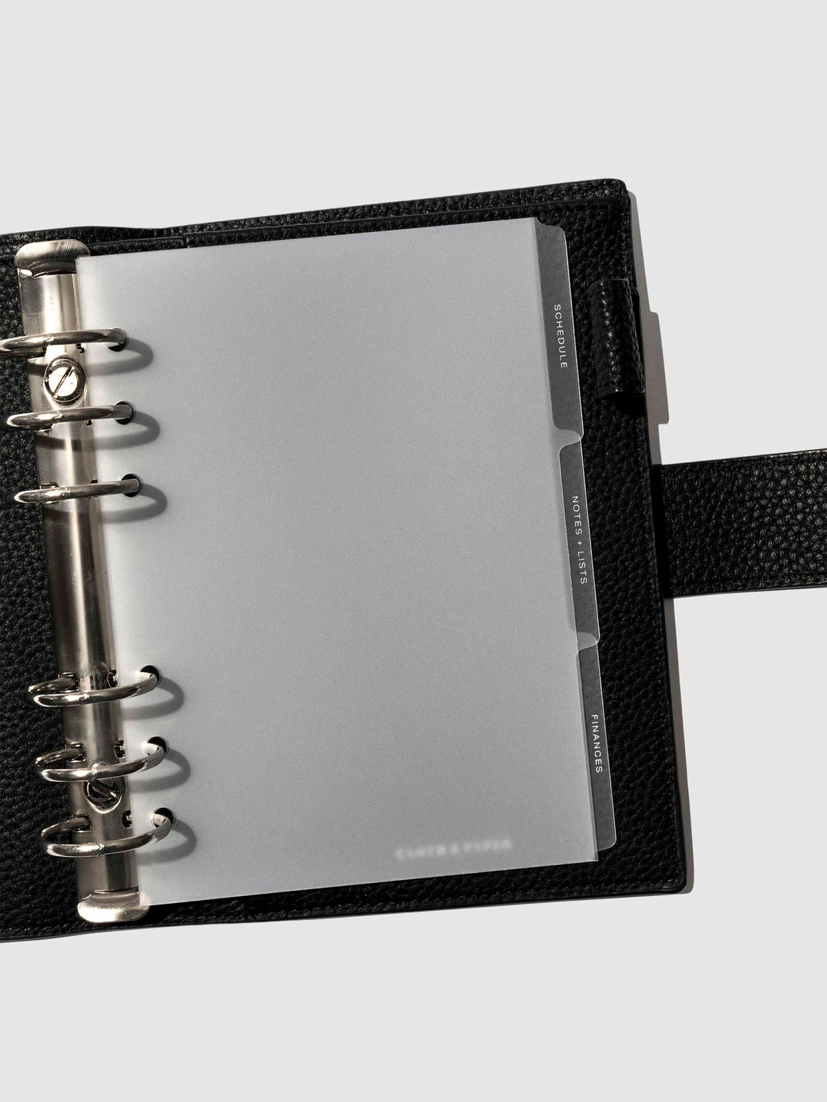 White foil tabs displayed in use inside a  leather folio.