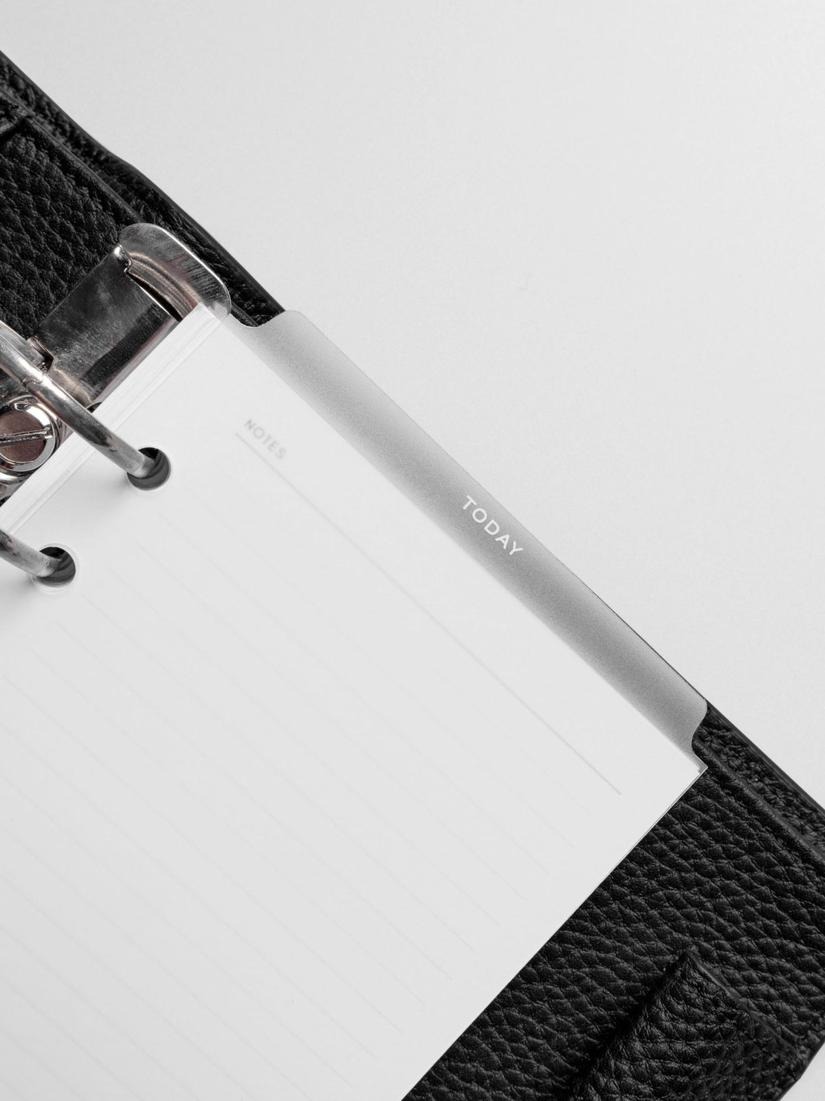 Divider in use inside a black leather planner.