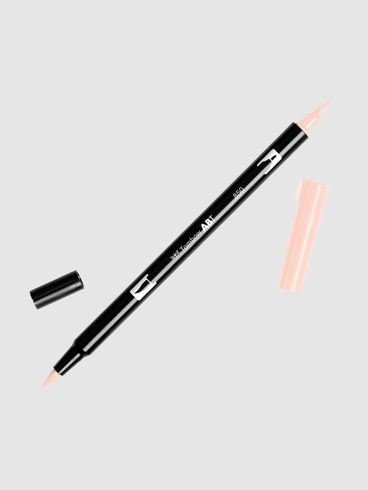 Tombow Dual Brush Art Marker, Light Apricot, Cloth & Paper. Art marker turned slightly to the right on a neutral background. It is uncapped on both ends showing the brush tip and fine tip.