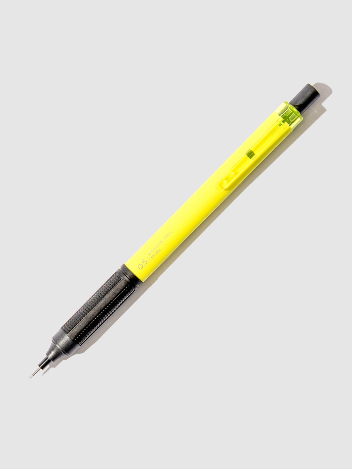 Neon yellow  pencil displayed on a neutral background.