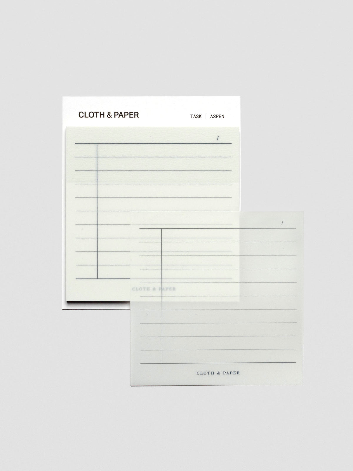 One transparent sticky note placed to the side of the pad, showing the translucent Aspen color and lined task format.