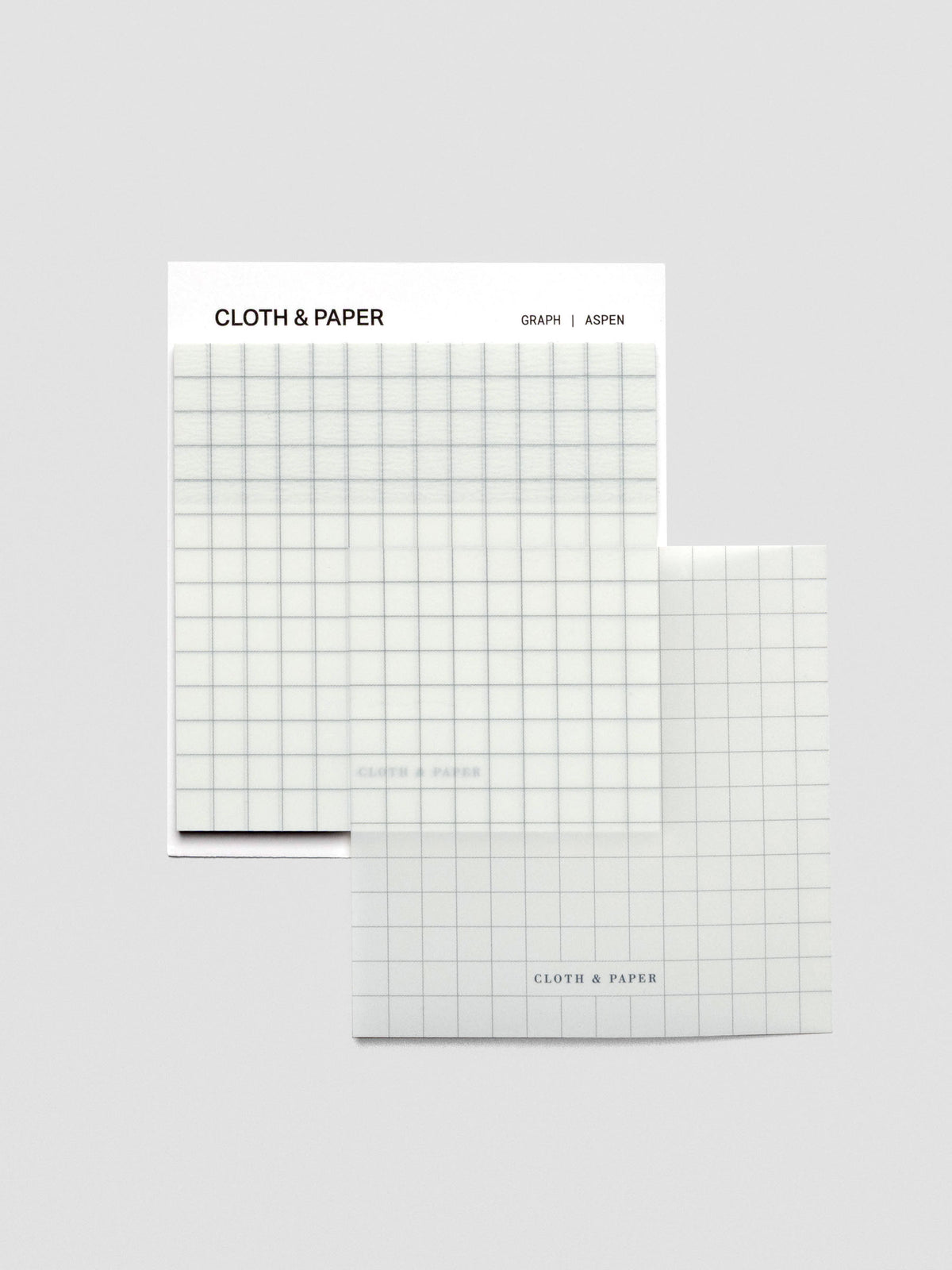 One transparent graph sticky note, placed on the side of the pad, stacked slightly off-center to display the transparent design.
