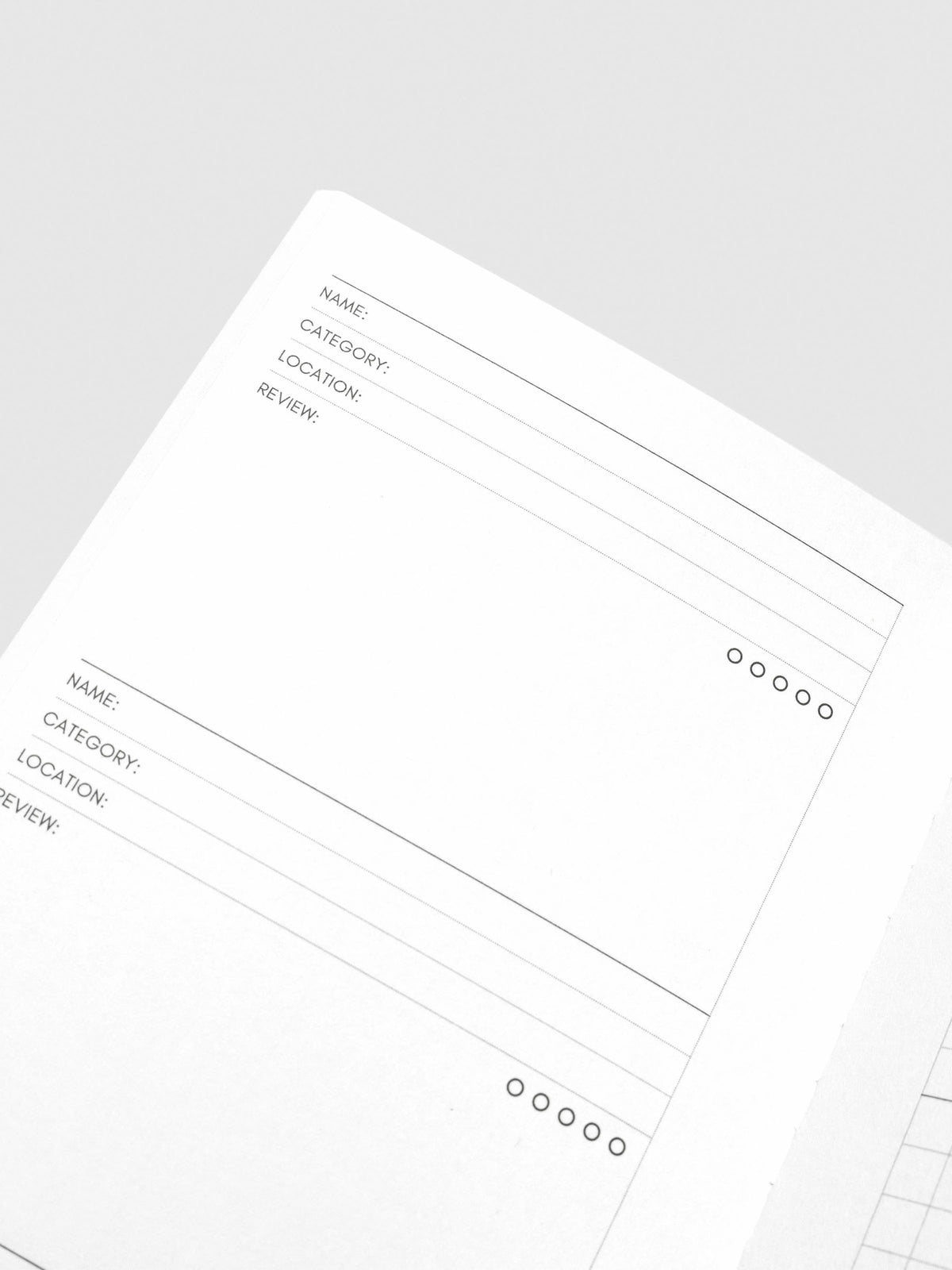 Close up image of the top left of the Experience Tracker Walnut Pocket Plus notebook page. The page is displayed on a neutral background.