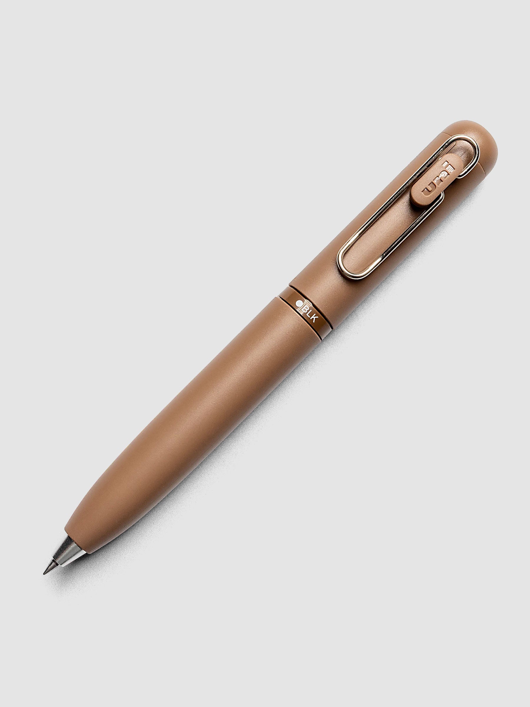Uni-ball One 3-Color Ballpoint Pen in brown laid diagonally showing clip and BLK color indicator