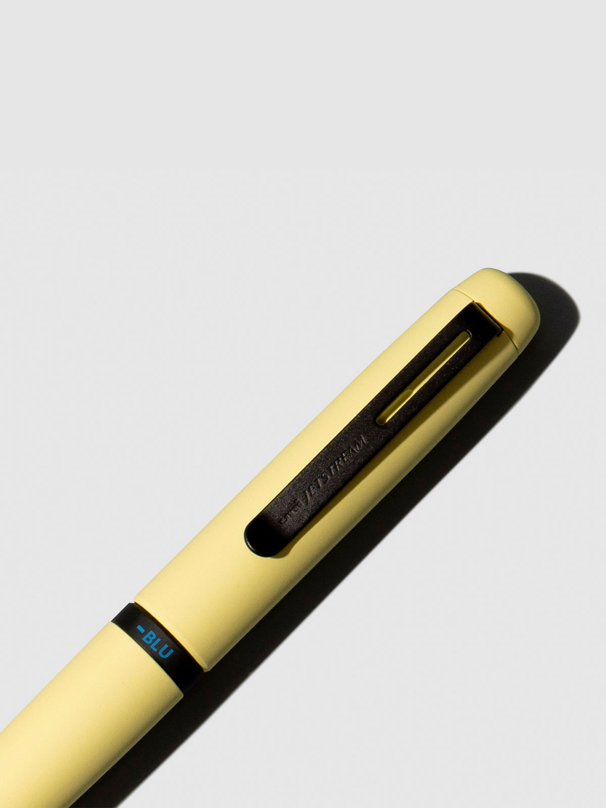 Pen shown close up, with the color selecting ring in focus. Pen ink color selected is blue, pen body is Citron Yellow.