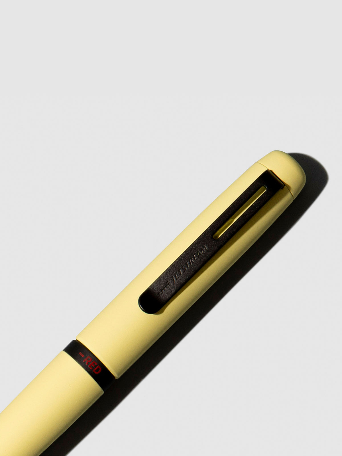 Pen shown close up, with the color selecting ring in focus. Pen ink color selected is red, pen body is Citron Yellow.