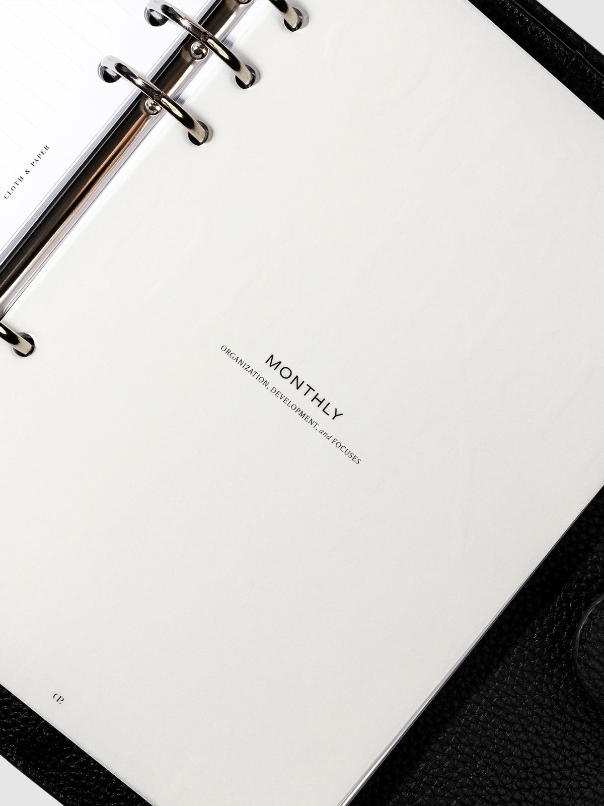 Monthly dashboard in use inside a leather planner.