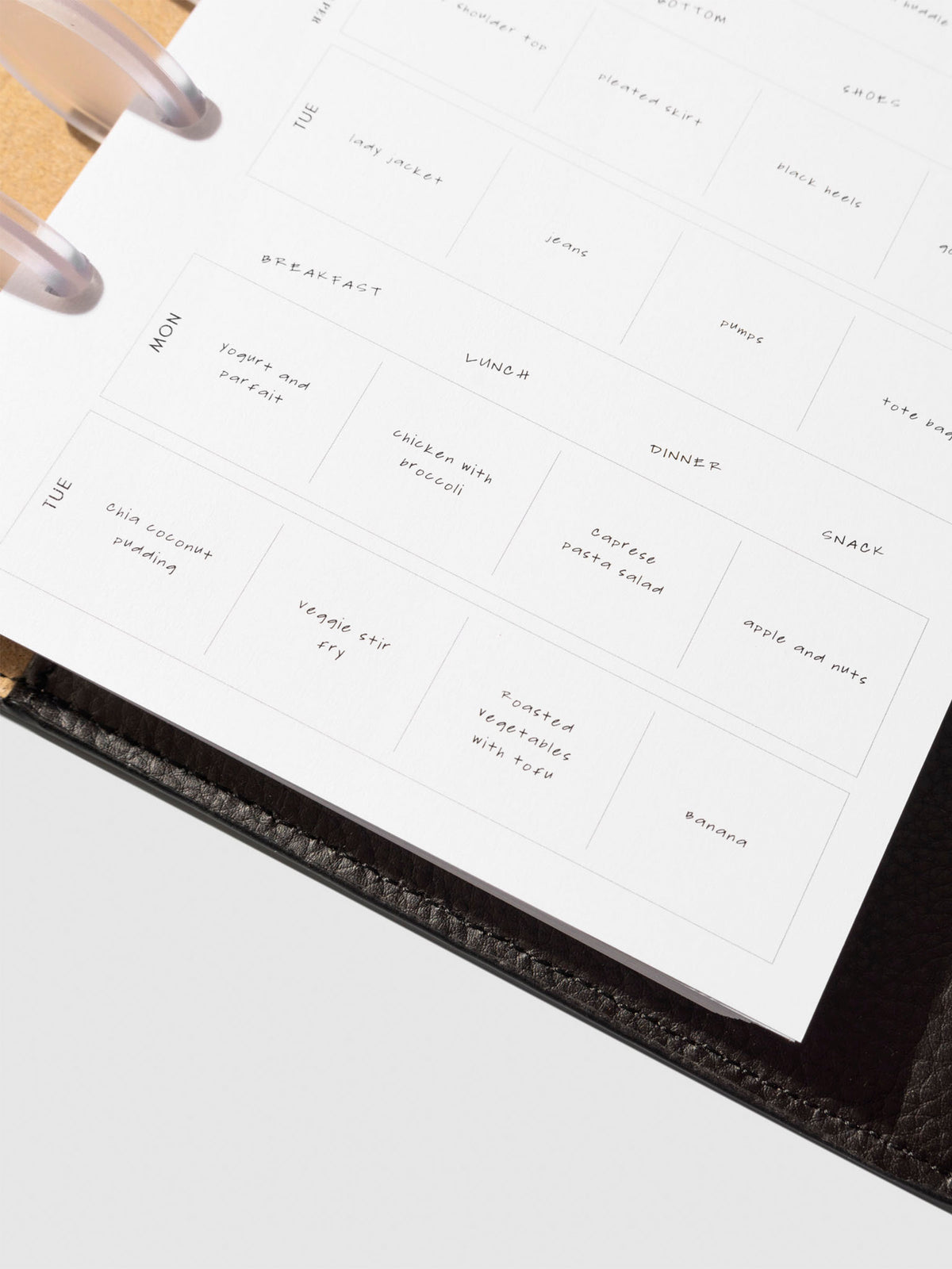 Closeup of insert in use inside a black leather planner.