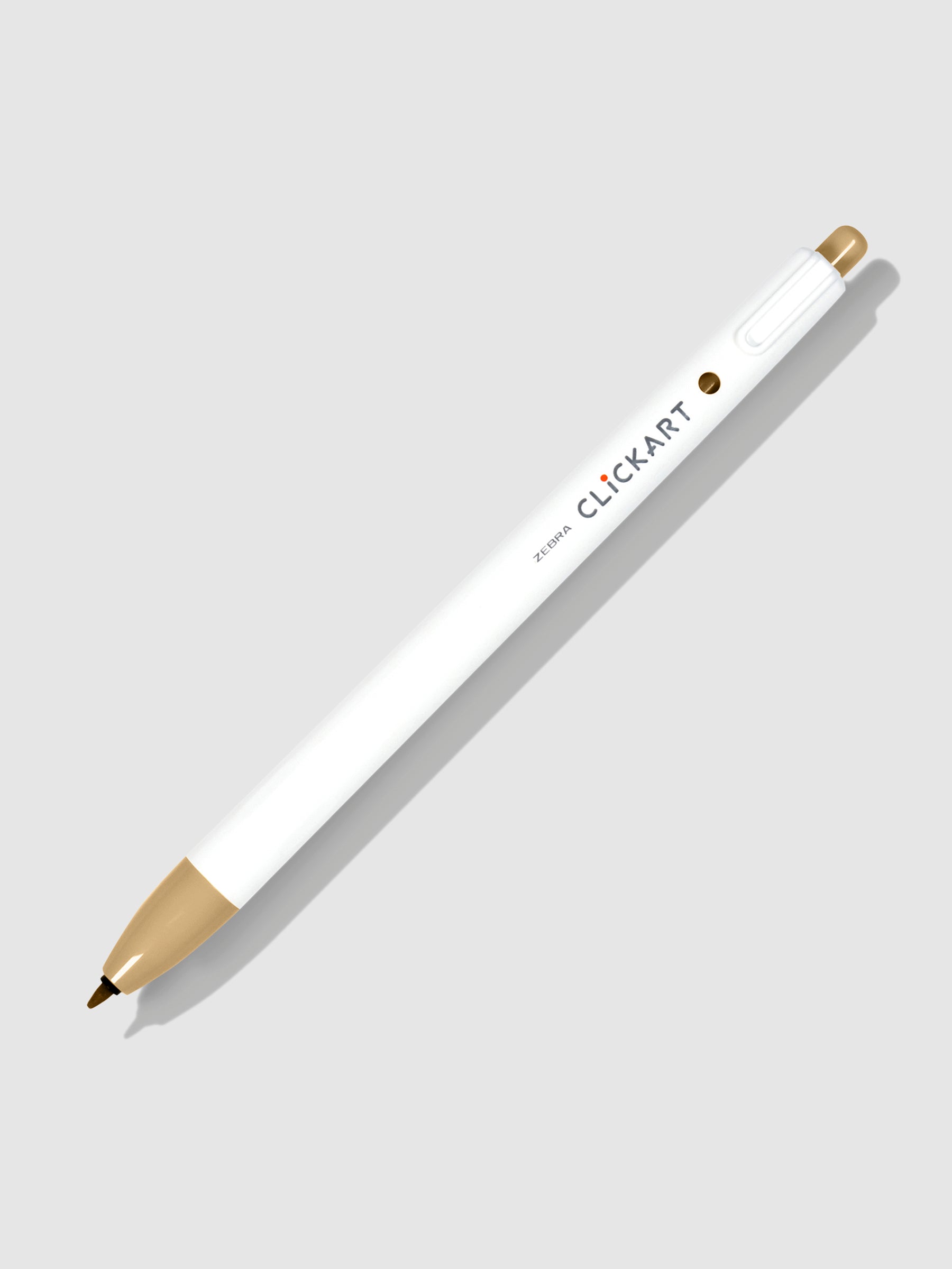 Zebra Clickart Marker in Light Brown tilted to the right on a neutral background with its nib exposed.