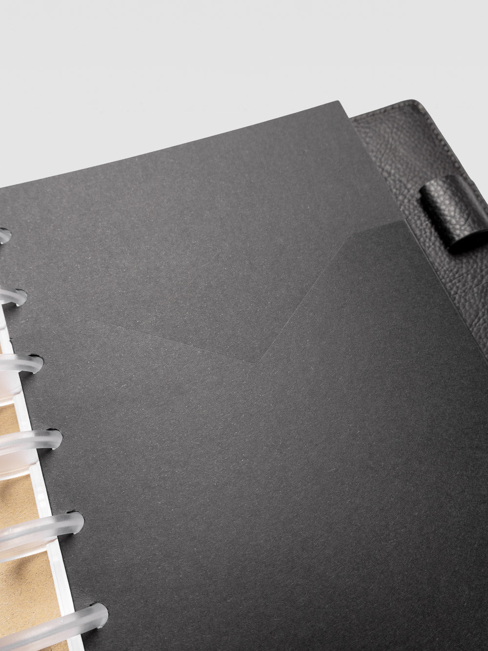 Detail view of the black planner paper pocket folder shown in size Half Letter 8-Disc Punch