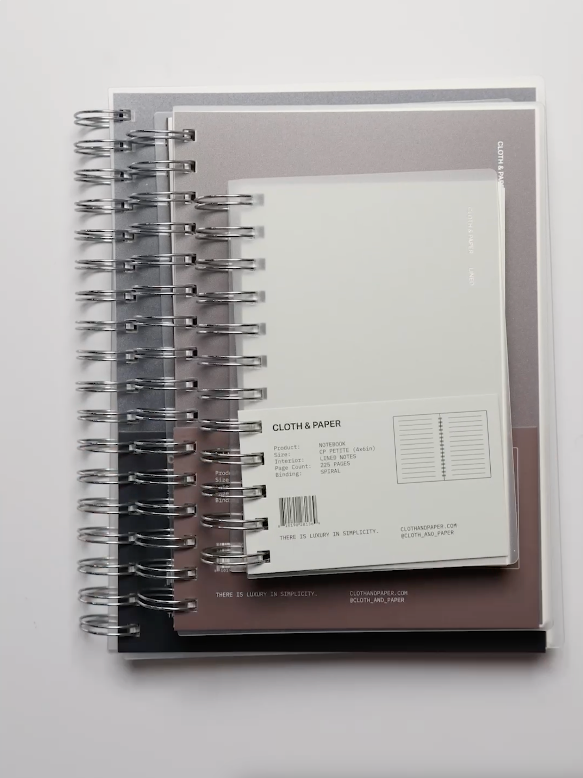 Cloth & Paper Spiral Notebooks shown in various sizes.
