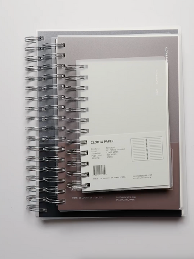 Cloth & Paper Spiral Notebooks shown in various sizes.